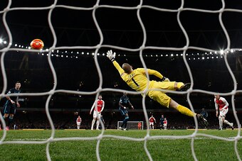 Manchester City's English goalkeeper Joe Hart fails to stop a shot from Arsenal's English midfielder Theo Walcott during the English Premier League football match between Arsenal and Manchester City at the Emirates Stadium in London on December 21, 2015. 