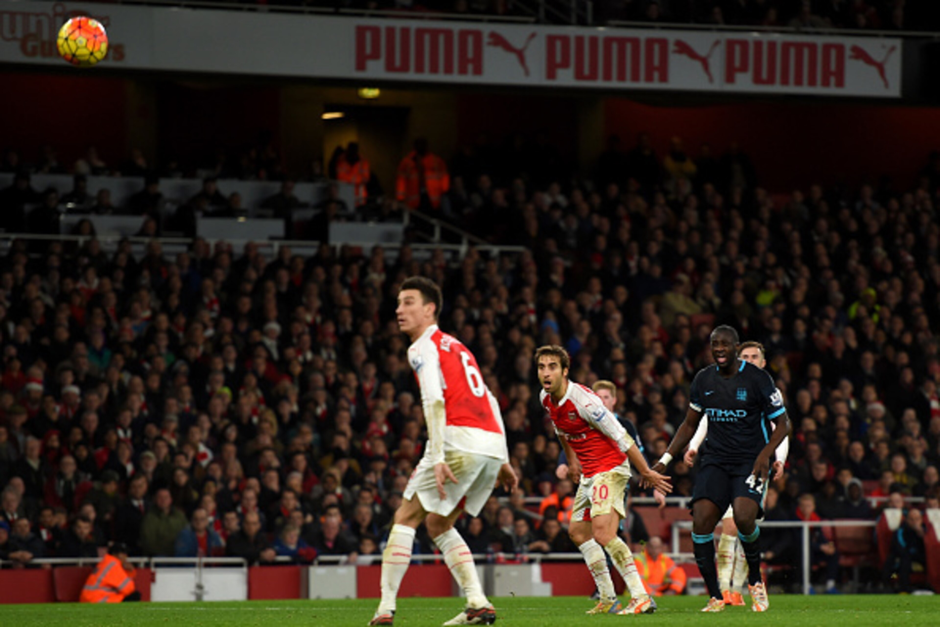 LONDON, ENGLAND - DECEMBER 21:  Yaya Toure of Manchester City (r) scores his side's first goal during the Barclays Premier League match between Arsenal and Manchester City at Emirates Stadium on December 21, 2015 in London, England.  (Photo by Michael Reg