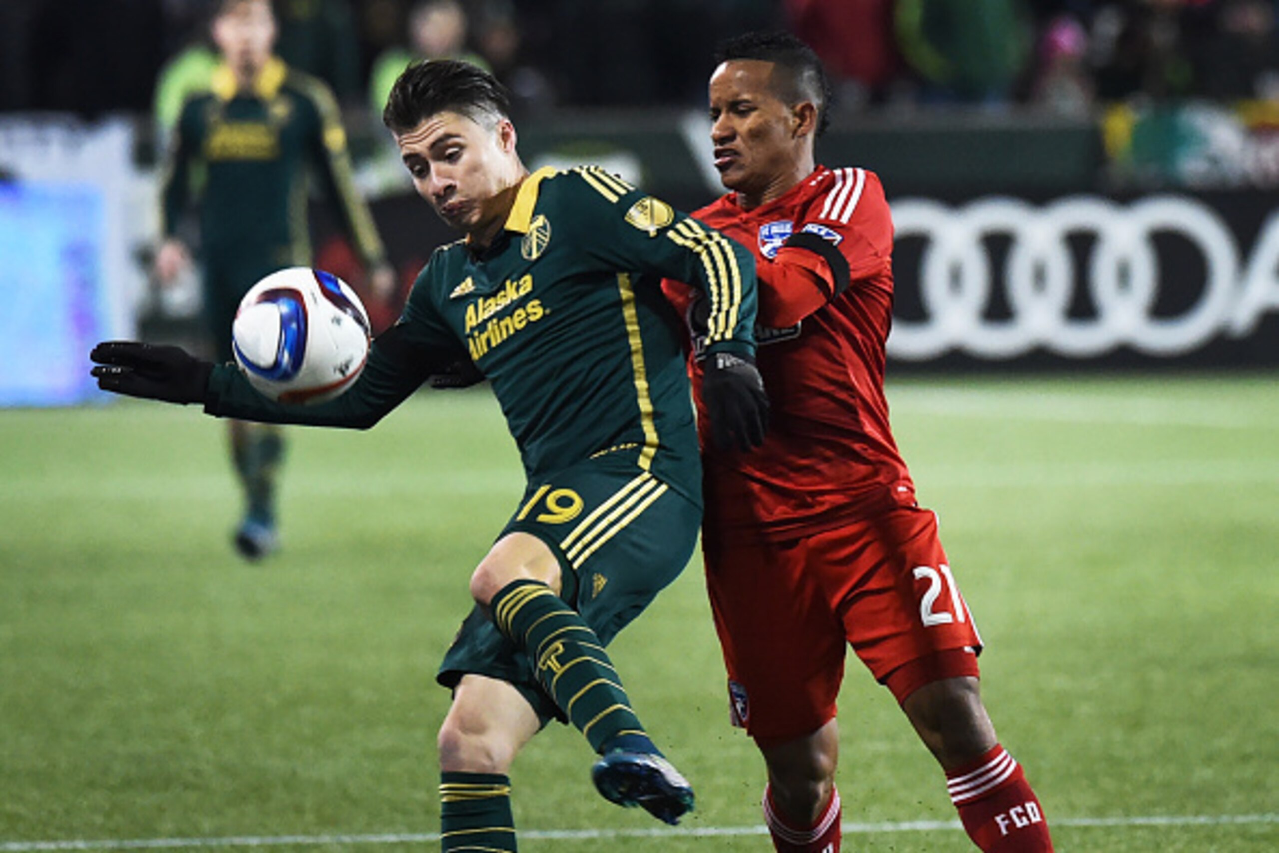 PORTLAND, OR - NOVEMBER 22: Jorge Villafana #19 of Portland Timbers and Michael Barrios #21 of FC Dallas battle for a ball during the second half of the match at Providence Park on November 22, 2015 in Portland, Oregon. (Photo by Steve Dykes/Getty Images)