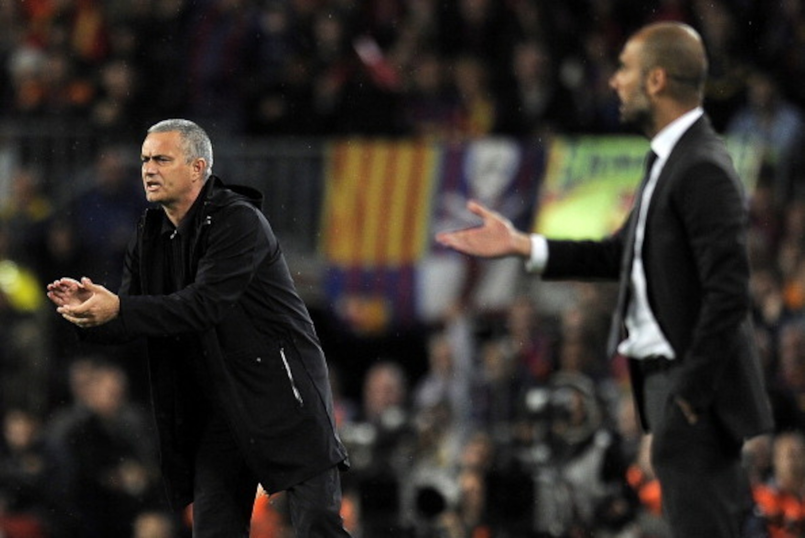 Real Madrid's Portuguese coach Jose Mourinho (L) and Barcelona's coach Josep Guardiola react during the Spanish League 'El clasico' football match Barcelona vs Real Madrid at the Camp Nou stadium in Barcelona on April 21, 2012. AFP PHOTO / LLUIS GENE (Pho Real Madrid's Portuguese coach Jose Mourinho (L) and Barcelona's coach Josep Guardiola react during the Spanish League 'El clasico' football match Barcelona vs Real Madrid at the Camp Nou stadium in Barcelona on April 21, 2012. AFP PHOTO / LLUIS GENE (Pho