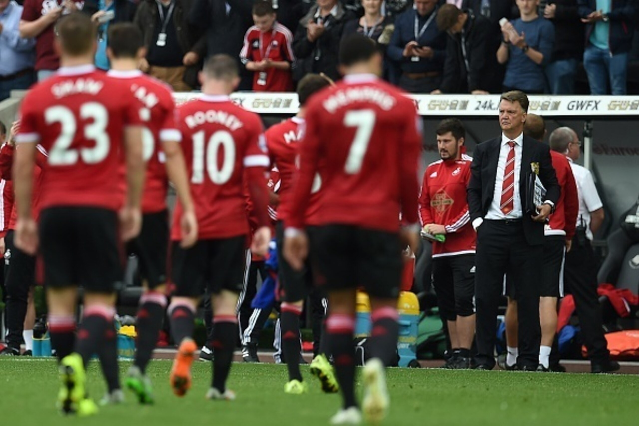 Manchester United's Dutch manager Louis van Gaal (R) watches his players leave the pitch following during the English Premier League football match between Swansea City and Manchester United at The Liberty Stadium in Swansea, south Wales on August 30, 201