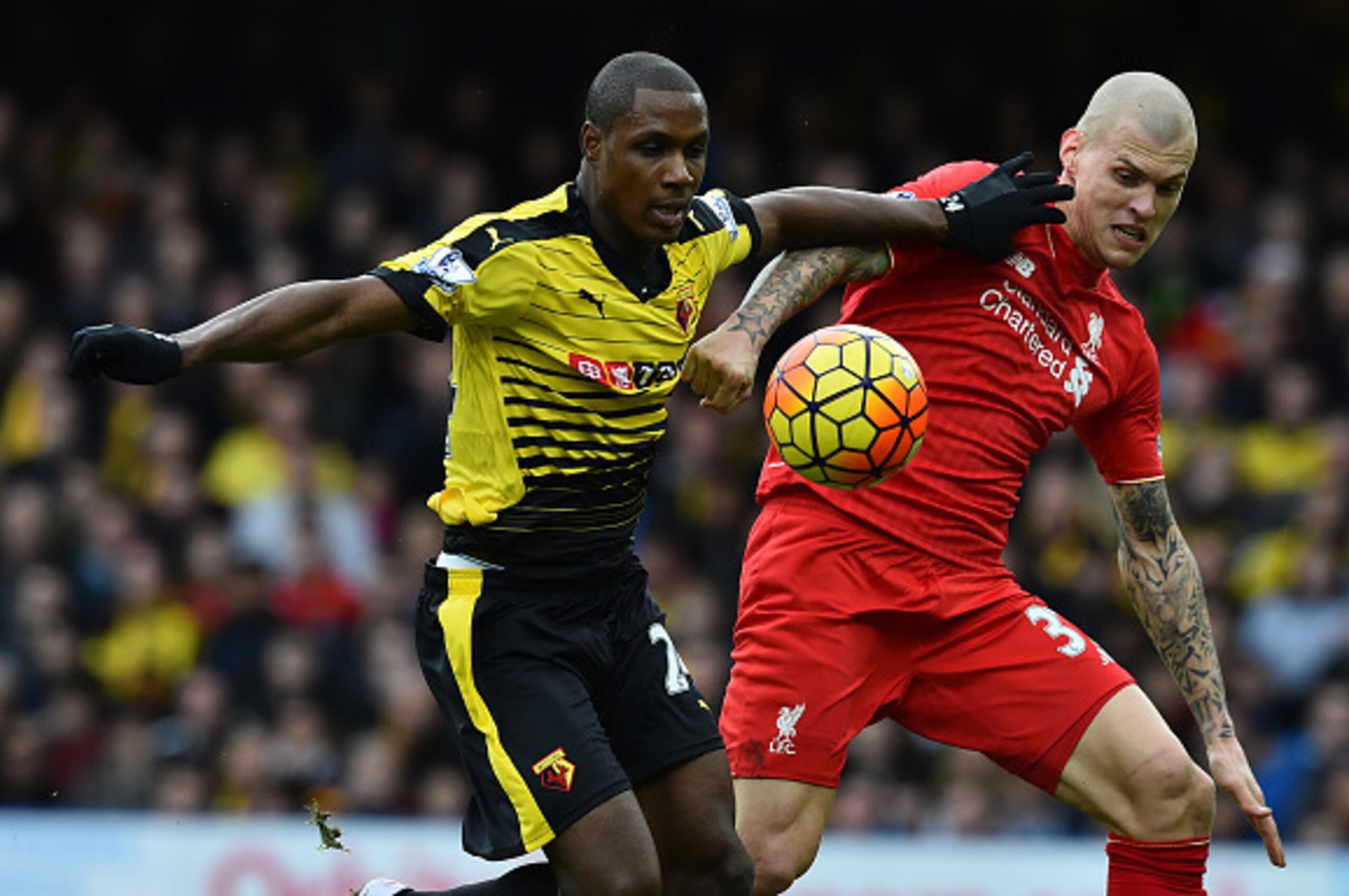 Watford's Nigerian striker Odion Ighalo (L) vies with Liverpool's Slovakian defender Martin Skrtel before scoring their second goal during the English Premier League football match between Watford and Liverpool at Vicarage Road Stadium in Watford, north o