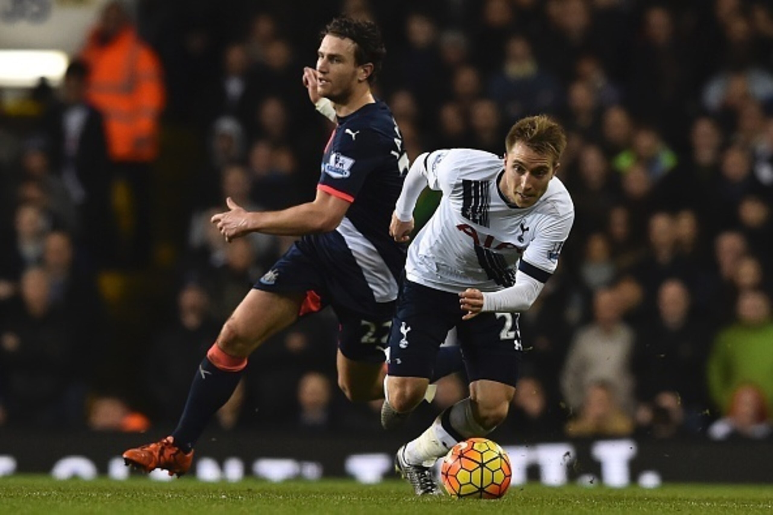 Tottenham Hotspur's Danish midfielder Christian Eriksen (R) spins away from Newcastle United's Dutch defender Daryl Janmaat (L) during the English Premier League football match between Tottenham Hotspur and Newcastle United at White Hart Lane in north Lon