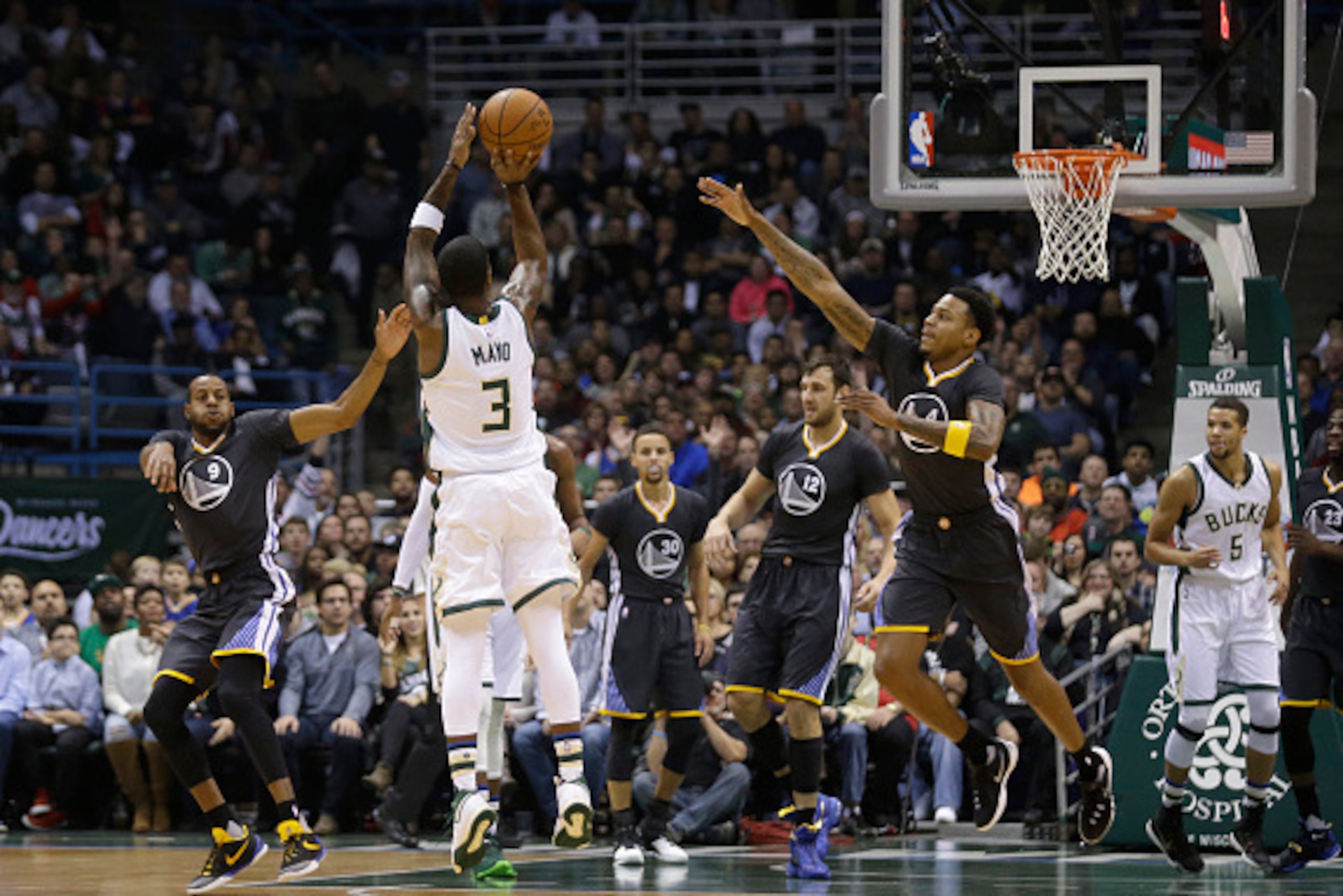 MILWAUKEE, WI - DECEMBER 12: O.J. Mayo #3 of the Milwaukee Bucks shoots a three pointer during the game against the Golden State Warriors at BMO Harris Bradley Center on December 12, 2015 in Milwaukee, Wisconsin. NOTE TO USER: User expressly acknowledges 