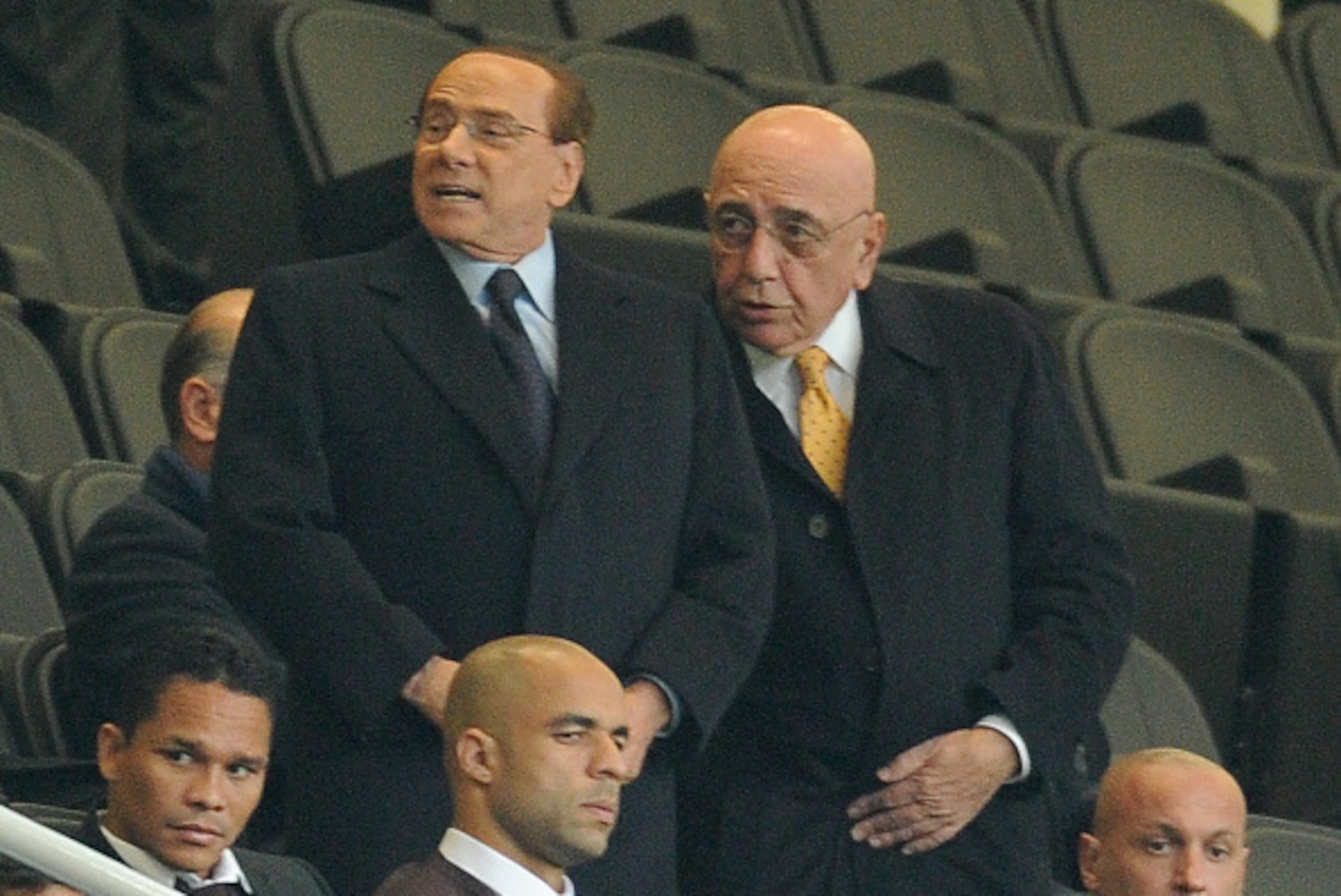 MILAN, ITALY - OCTOBER 21:  (L-R) President of AC Milan Silvio Berlusconi and Adriano Galliani atend the Berlusconi Trophy match between AC Milan and FC Internazionale at Stadio Giuseppe Meazza on October 21, 2015 in Milan, Italy.  (Photo by Pier Marco Ta