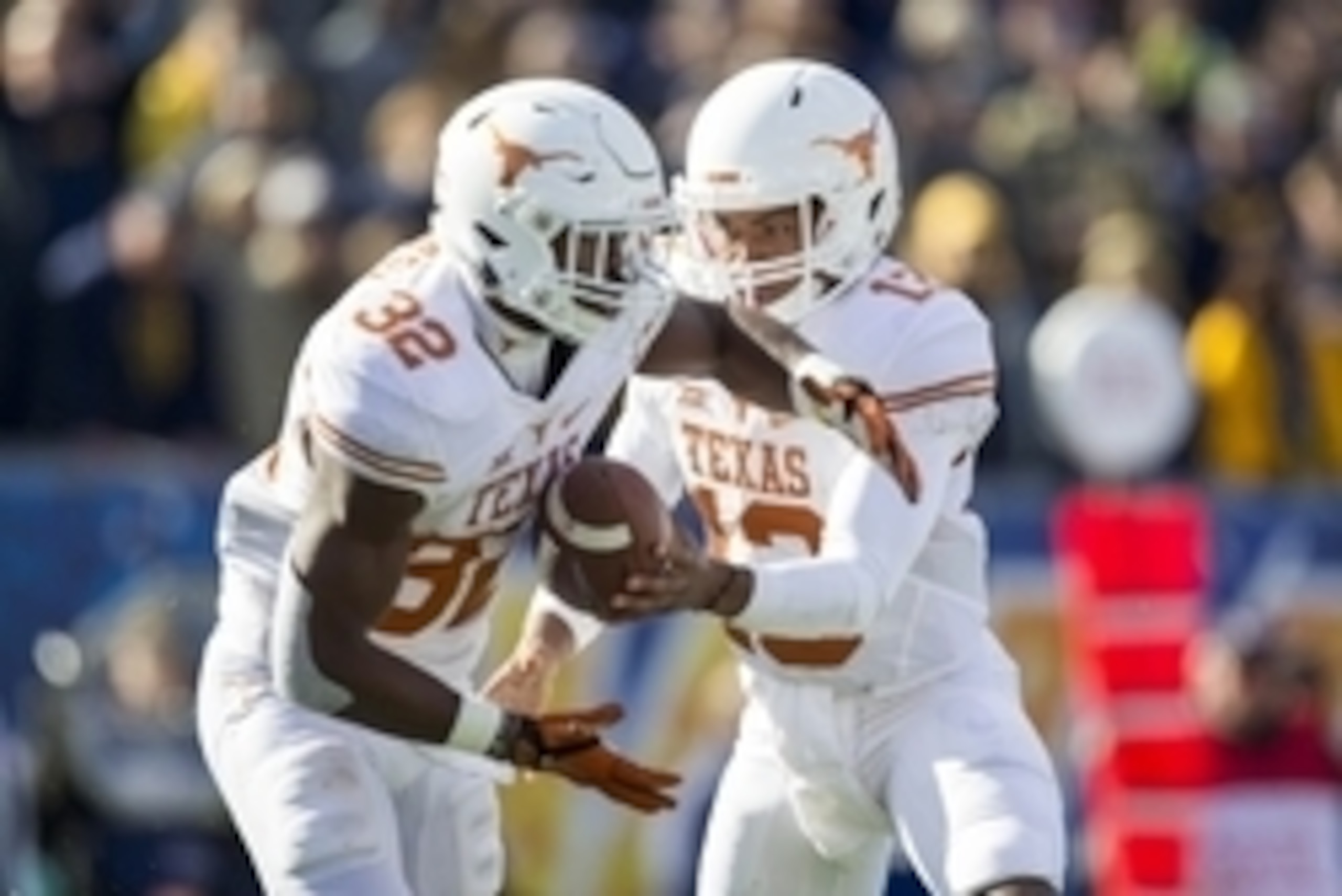 Nov 14, 2015; Morgantown, WV, USA; Texas Longhorns quarterback Jerrod Heard hands the ball off to running back Johnathan Gray during the second quarter against the West Virginia Mountaineers at Milan Puskar Stadium. Mandatory Credit: Ben Queen-USA TODAY S