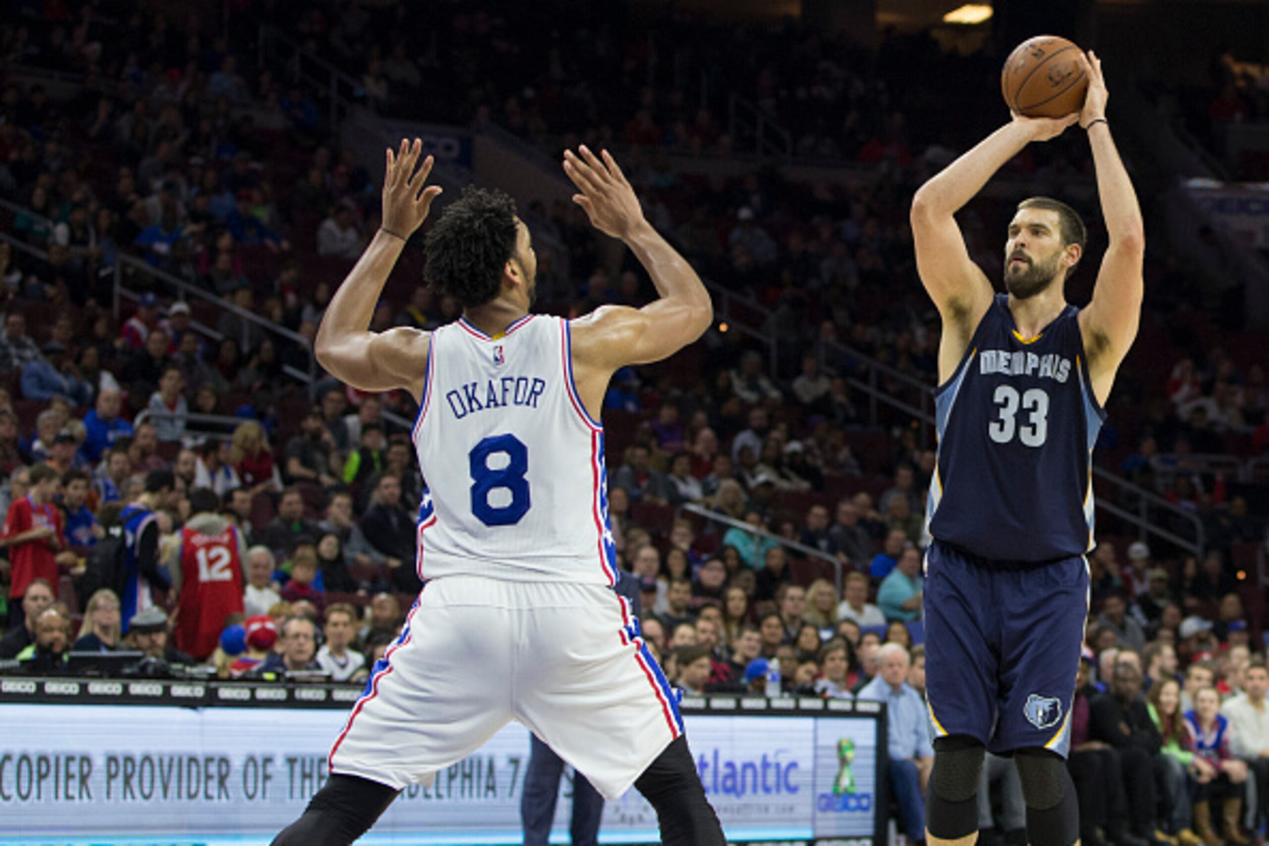 PHILADELPHIA, PA - DECEMBER 22: Marc Gasol #33 of the Memphis Grizzlies attempts a shot over Jahlil Okafor #8 of the Philadelphia 76ers on December 22, 2015 at the Wells Fargo Center in Philadelphia, Pennsylvania. The Grizzles defeated the 76ers 104-90.  