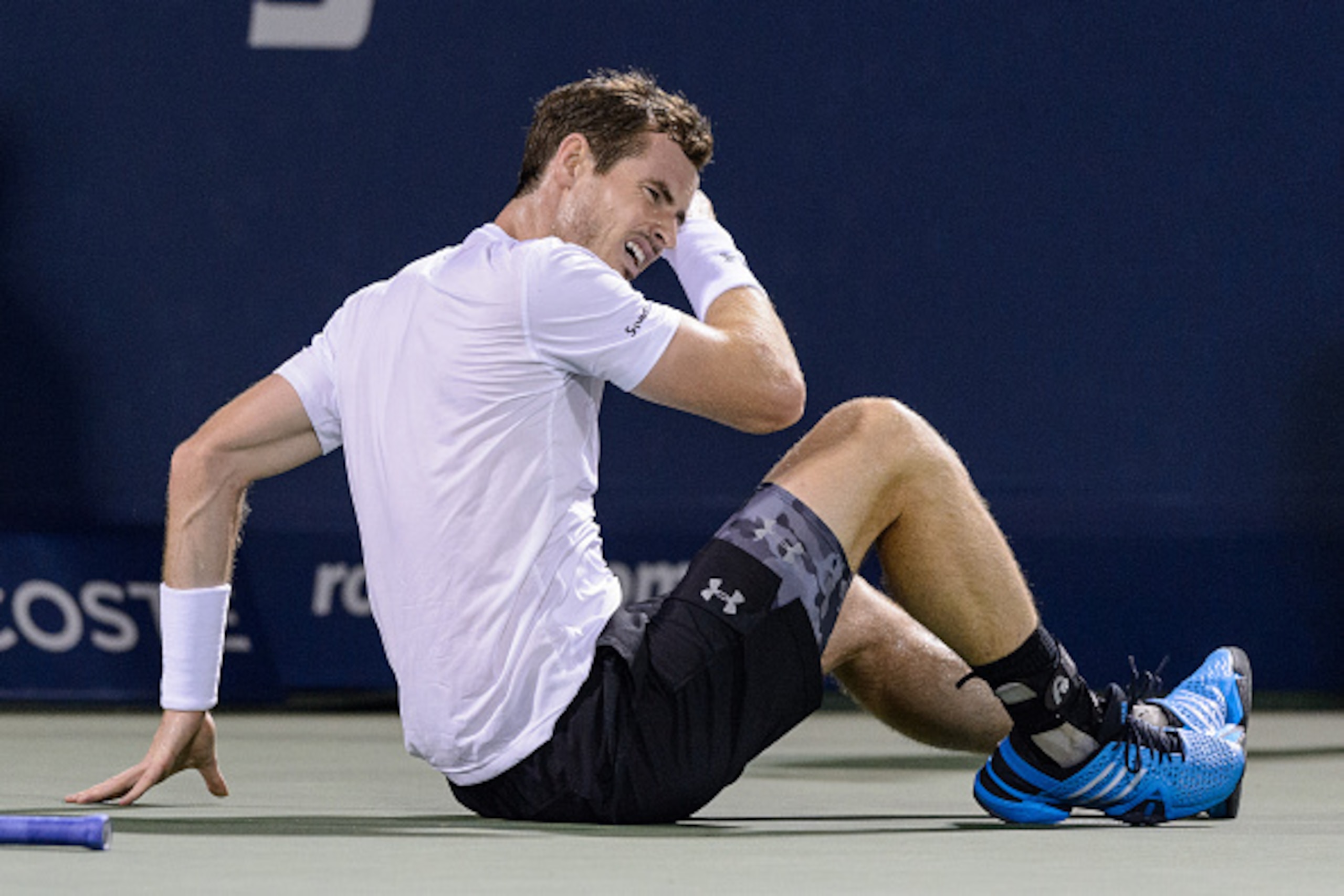 MONTREAL, ON - AUGUST 14:  Andy Murray of Great Britain slips and falls against Jo-Wilfried Tsonga of France during day five of the Rogers Cup at Uniprix Stadium on August 14, 2015 in Montreal, Quebec, Canada.  (Photo by Minas Panagiotakis/Getty Images)