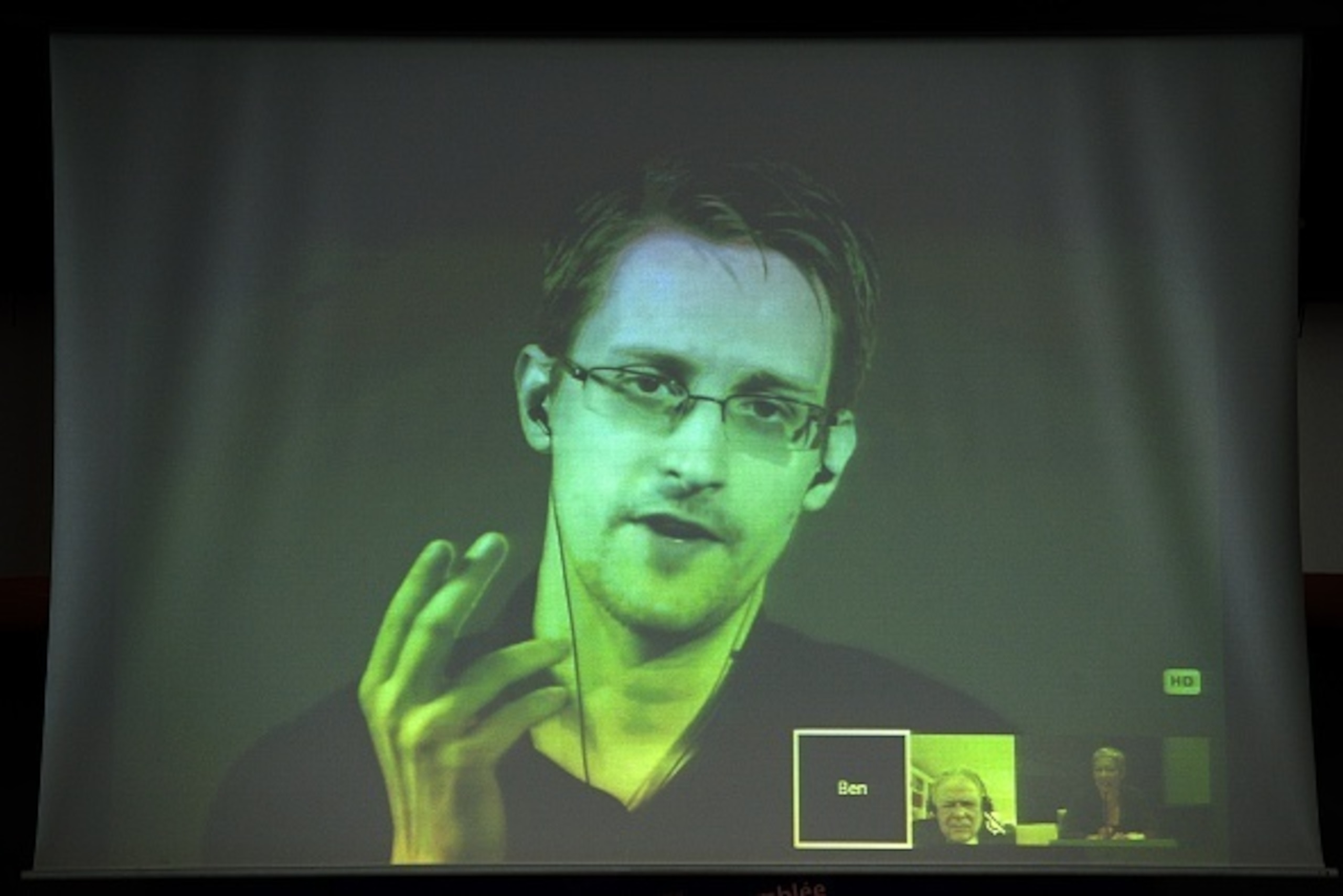NSA former intelligence contractor Edward Snowden talks as he participates via video link from Russia to a parliamentary hearing on the subject of 'Improving the protection of whistleblowers' on June 23, 2015, at the Council of Europe in Strasbourg, north