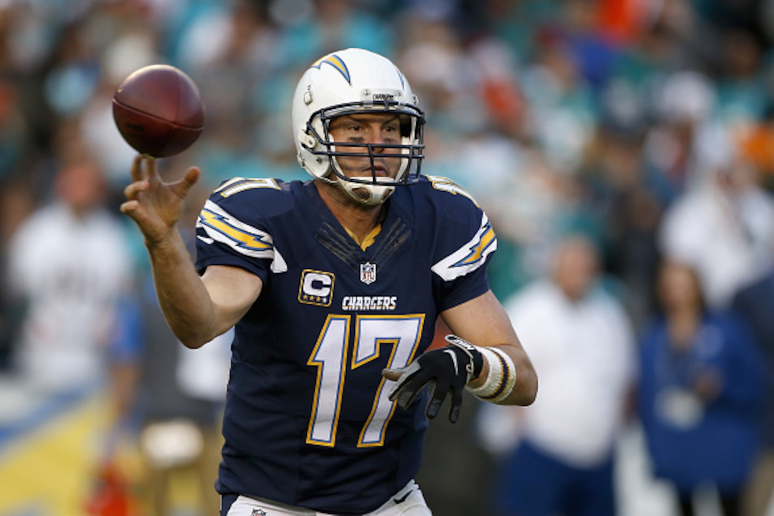 SAN DIEGO, CA - DECEMBER 20:  Philip Rivers #17 of the San Diego Chargers passes against the Miami Dolphins defense at Qualcomm Stadium on December 20, 2015 in San Diego, California.  (Photo by Todd Warshaw/Getty Images)