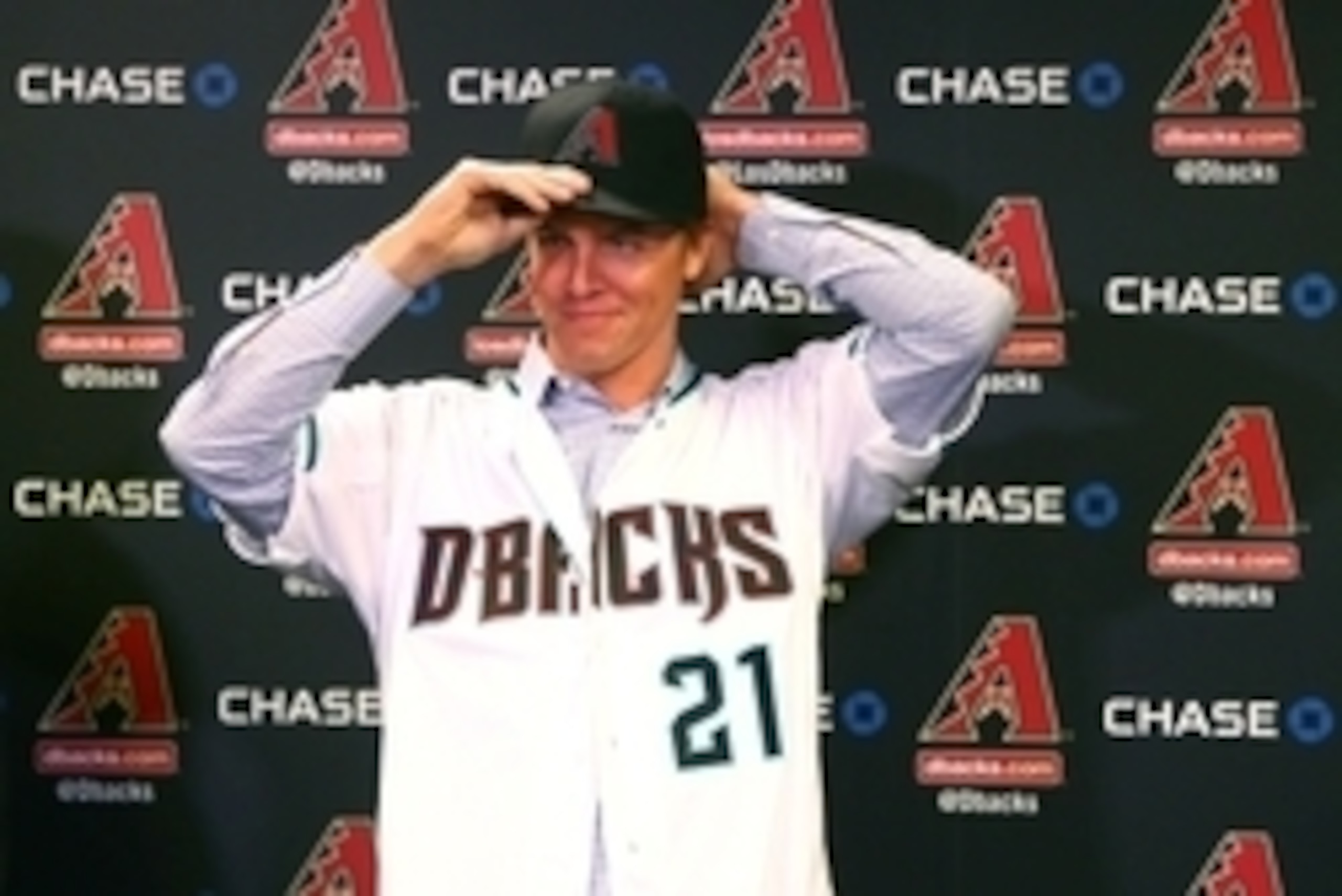 Dec 11, 2015; Phoenix, AZ, USA; Arizona Diamondbacks pitcher Zack Greinke puts on a baseball hat during a press conference at Chase Field . Mandatory Credit: Mark J. Rebilas-USA TODAY Sports