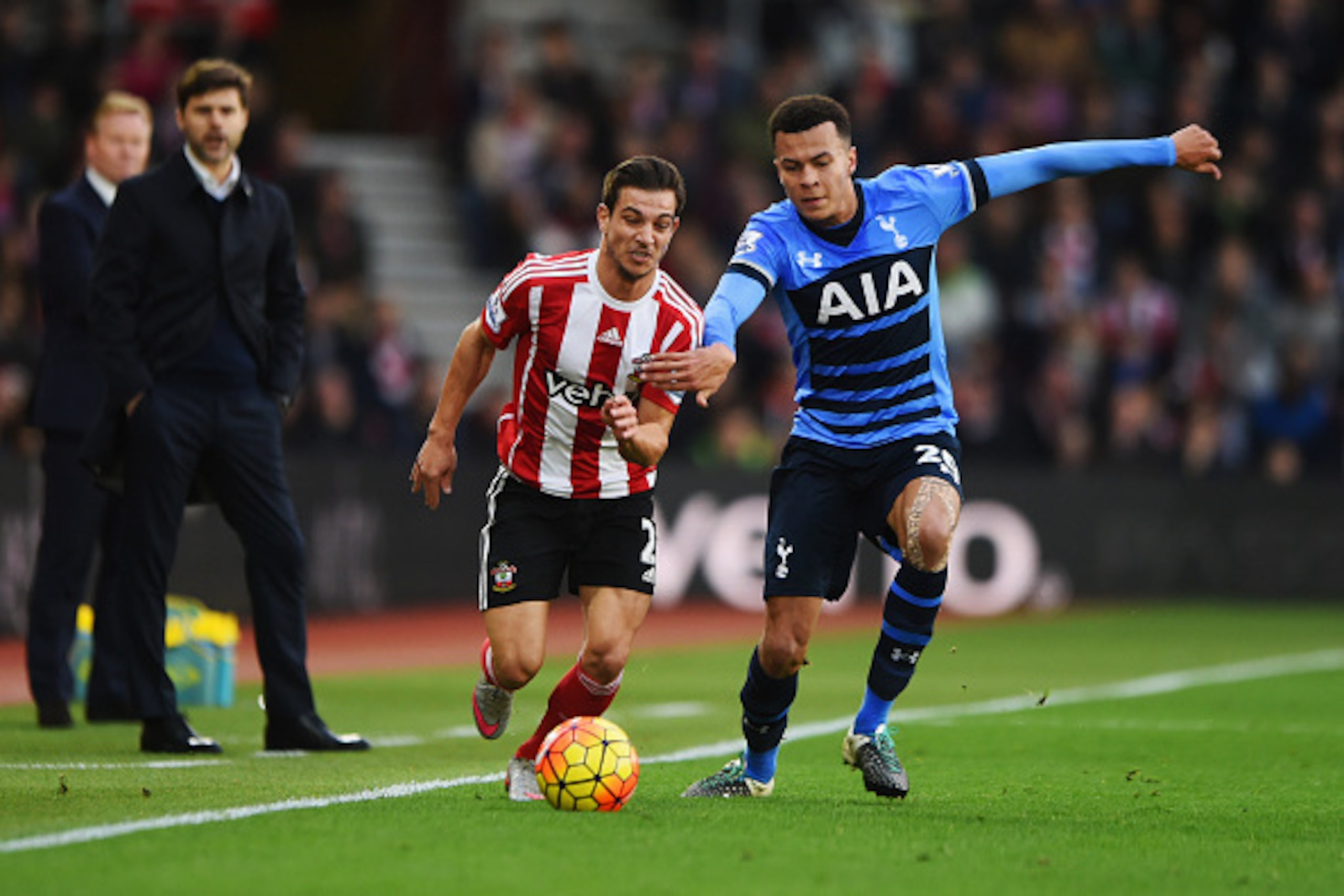 SOUTHAMPTON, ENGLAND - DECEMBER 19:  Ronald Koeman manager of Southampton and Mauricio Pochettino manager of Tottenham Hotspur watch Cedric Soares of Southampton and Dele Alli of Tottenham Hotspur in action during the Barclays Premier League match between