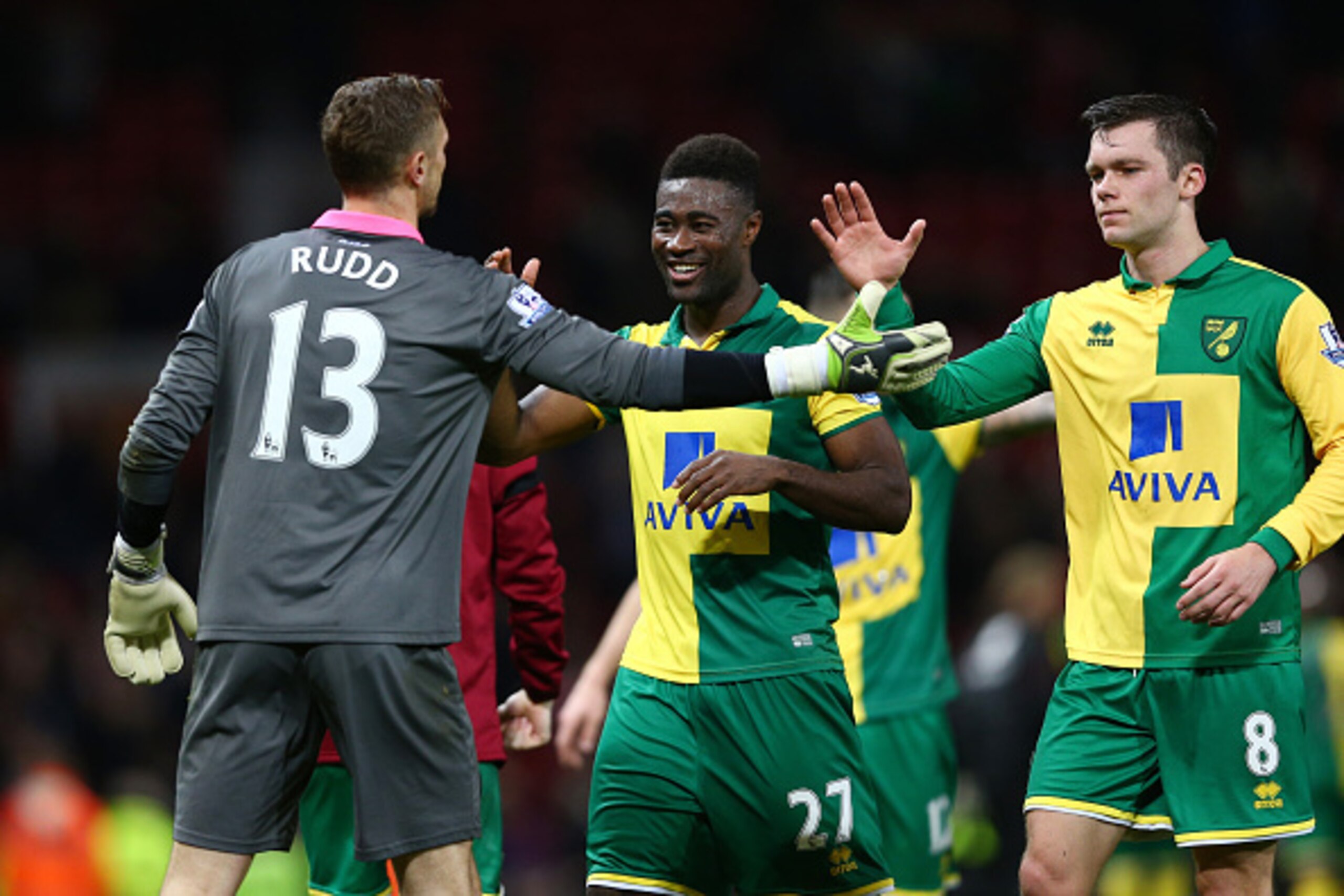 MANCHESTER, ENGLAND - DECEMBER 19: (L to R) Declan Rudd, Alexander Tettey and Jonathan Howson of Norwich City celebrate their 2-1 win in the Barclays Premier League match between Manchester United and Norwich City at Old Trafford on December 19, 2015 in M