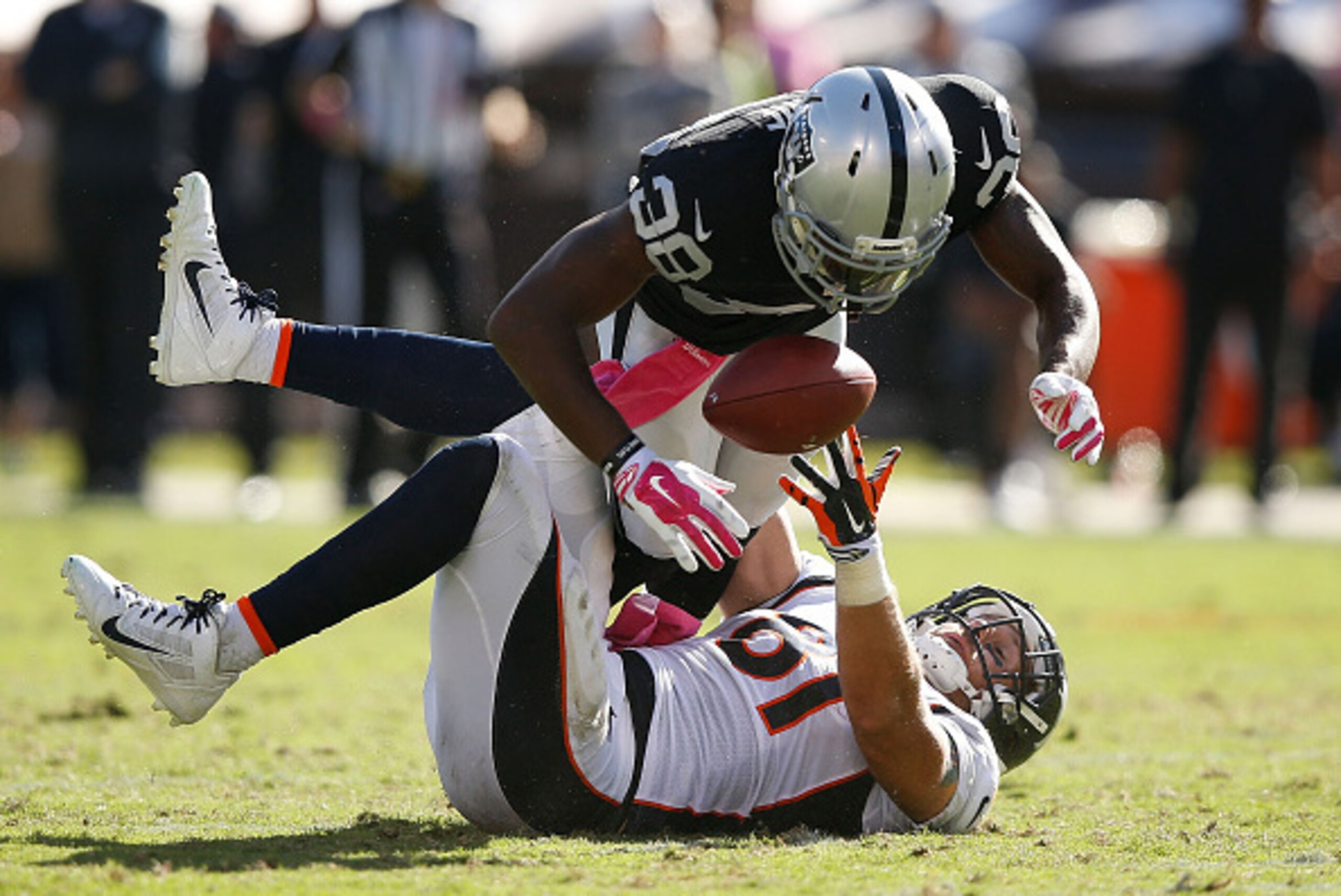OAKLAND, CA - OCTOBER 11: Matt Paradis #61 of the Denver Broncos misses a pass under pressure from T.J. Carrie #38 of the Oakland Raiders in the fourth quarter at O.co Coliseum on October 11, 2015 in Oakland, California. (Photo by Ezra Shaw/Getty Images)