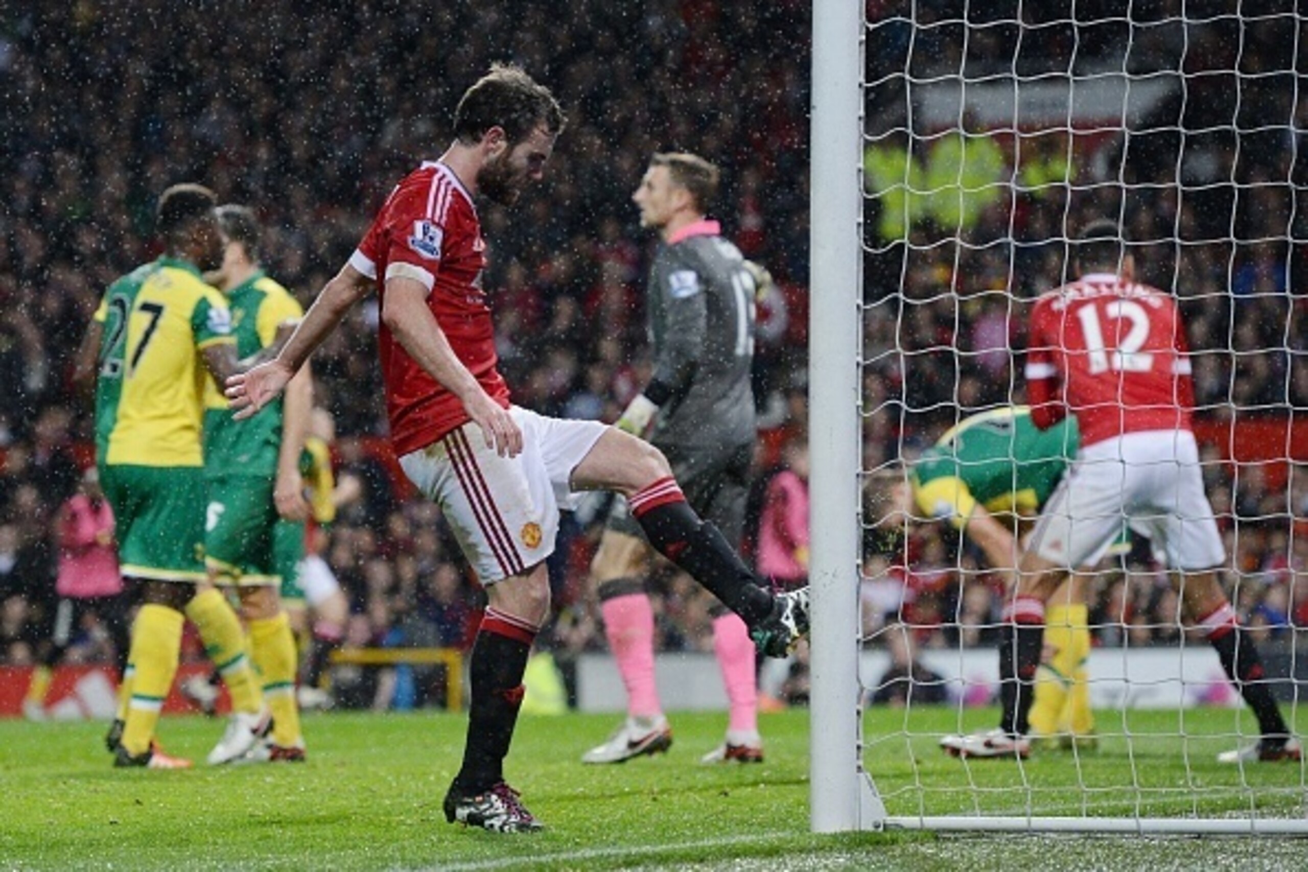 Manchester United's Spanish midfielder Juan Mata (3rd L) kicks a goalpost after missing a chance during the English Premier League football match between Manchester United and Norwich City at Old Trafford in Manchester, north west England on December 19, 