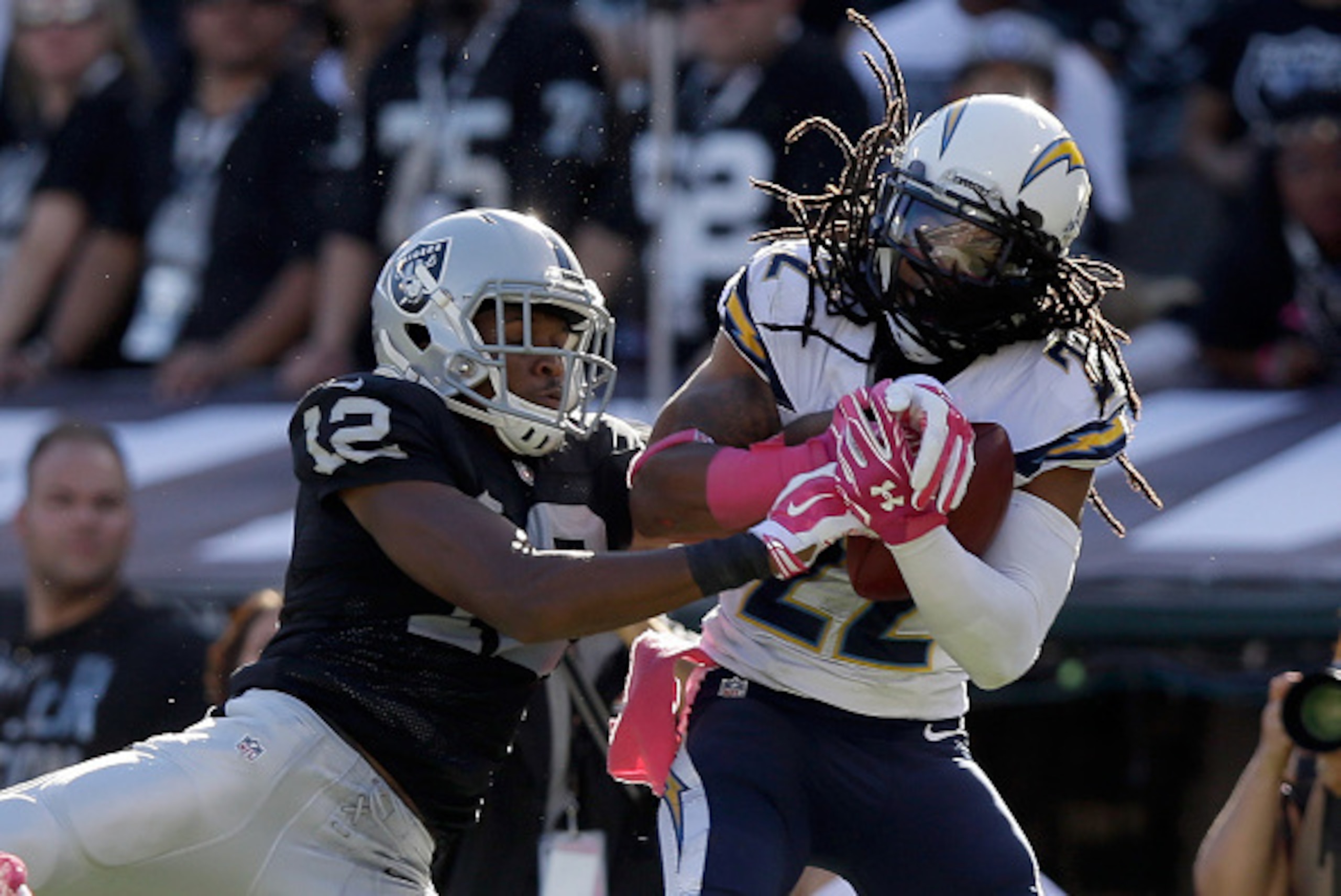 OAKLAND, CA - OCTOBER 12:  Jason Verrett #22 of the San Diego Chargers intercepts a pass intended for Brice Butler #12 of the Oakland Raiders in the fourth quarter that clinched their victory at O.co Coliseum on October 12, 2014 in Oakland, California.  (