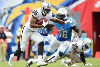 SAN DIEGO, CA - OCTOBER 25:  Amari Cooper #89 of the Oakland Raiders runs after a catch as he is chased by Donald Butler #56 of the San Diego Chargers at Qualcomm Stadium on October 25, 2015 in San Diego, California.  (Photo by Harry How/Getty Images)
