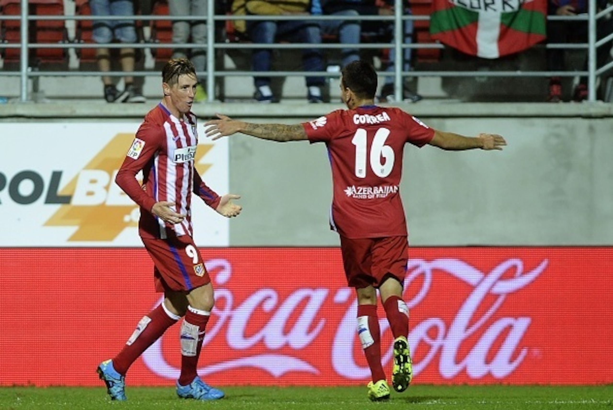 Atletico Madrid's forward Fernando Torres (L) celebrates a goal with teammate Argentinian midfielder Angel Correa (R) during the Spanish league football match SD Eibar vs Club Atletico de Madrid at the Ipurua stadium in Eibar on September 19, 2015.   AFP 