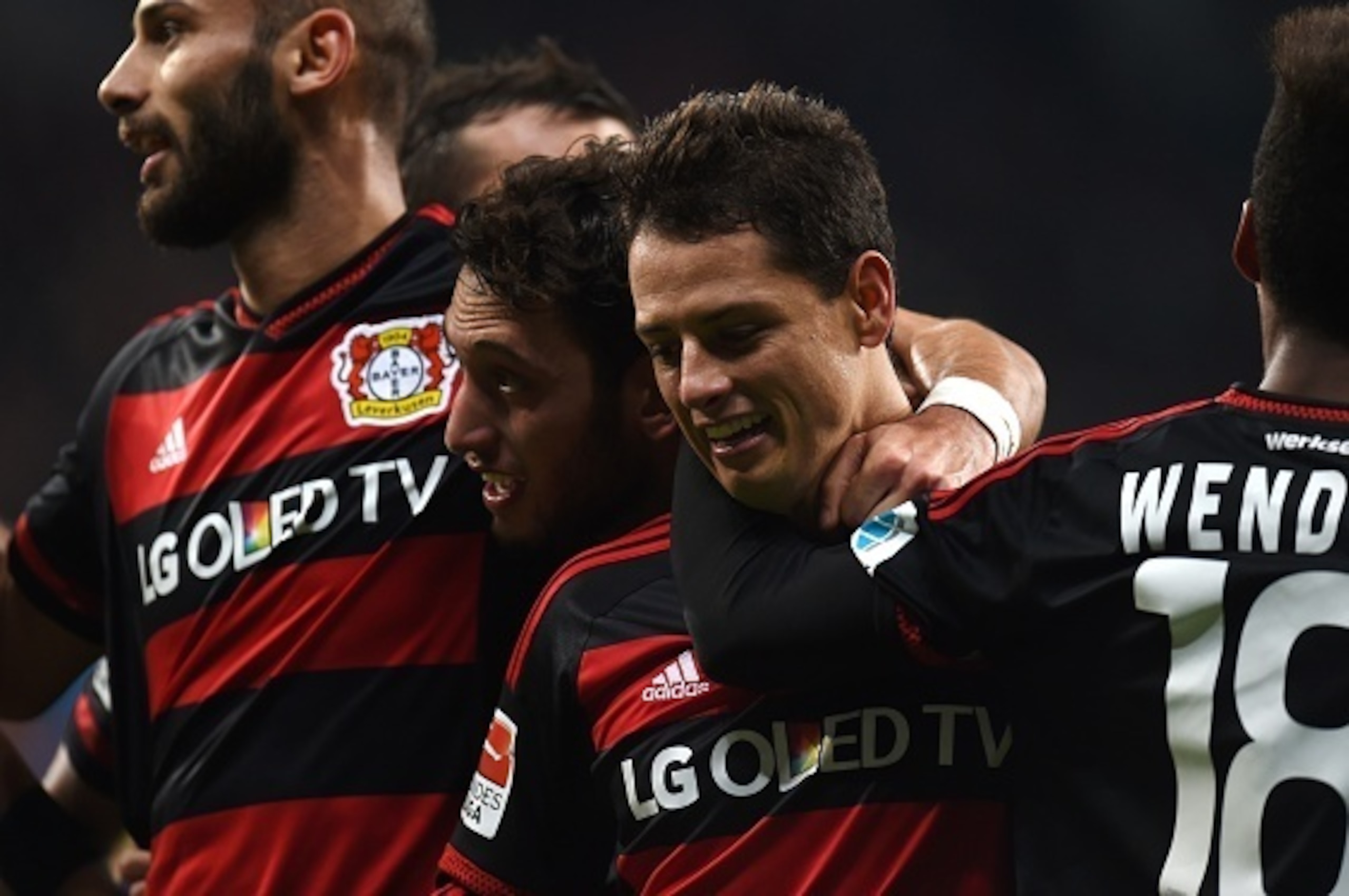 Leverkusen's Mexican striker Javier Hernandez (2nd R) and his teammates celebrate during the German first division Bundesliga football match Bayer 04 Leverkusen vs Borussia Moenchengladbach in Leverkusen, western Germany, on December 12, 2015. Leverkusen 