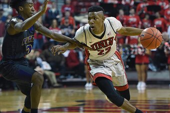 LAS VEGAS, NV - NOVEMBER 28:  Patrick McCaw #22 of the UNLV Rebels drives against Avery Lomax #2 of the Prairie View A&M Panthers during their game at the Thomas & Mack Center on November 28, 2015 in Las Vegas, Nevada. UNLV won 80-62.  (Photo by Ethan Mil