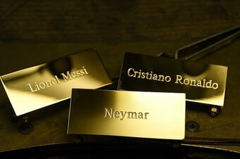 A picture taken on December 15, 2015 shows three plaques reading, 'Cristiano Ronaldo', 'Lionel Messi' and 'Neymar' at the Mellerio jewellers in Paris.
Barcelona's Argentinian forward Lionel Messi, Barcelona's Brazilian forward Neymar and Real Madrid's Por