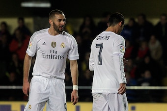 Real Madrid's French forward Karim Benzema (L) misses an attempt on goal beside Real Madrid's Portuguese forward Cristiano Ronaldo during the Spanish league football match Villarreal CF vs Real Madrid CF at El Madrigal stadium in Villareal on December 13,
