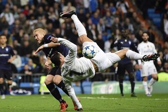 Real Madrid's Portuguese forward Cristiano Ronaldo (R) kicks the ball past Malmo's defender Anton Tinnerholm during the UEFA Champions League Group A football match Real Madrid CF vs Malmo FF at the Santiago Bernabeu stadium in Madrid on December 8, 2015.