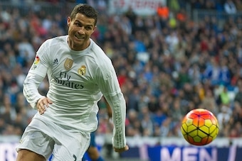 Real Madrid's Portuguese forward Cristiano Ronaldo runs for the ball during the Spanish league football match Real Madrid CF vs Getafe CF at the Santiago Bernabeu stadium in Madrid on December 5, 2015.  / AFP / CURTO DE LA TORRE        (Photo credit shoul