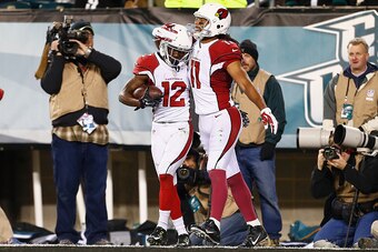 PHILADELPHIA, PA - DECEMBER 20:  John Brown #12 of the Arizona Cardinals celebrates his touchdown catch with teammate Larry Fitzgerald #11 in the third quater against the Philadelphia Eagles at Lincoln Financial Field on December 20, 2015 in Philadelphia,