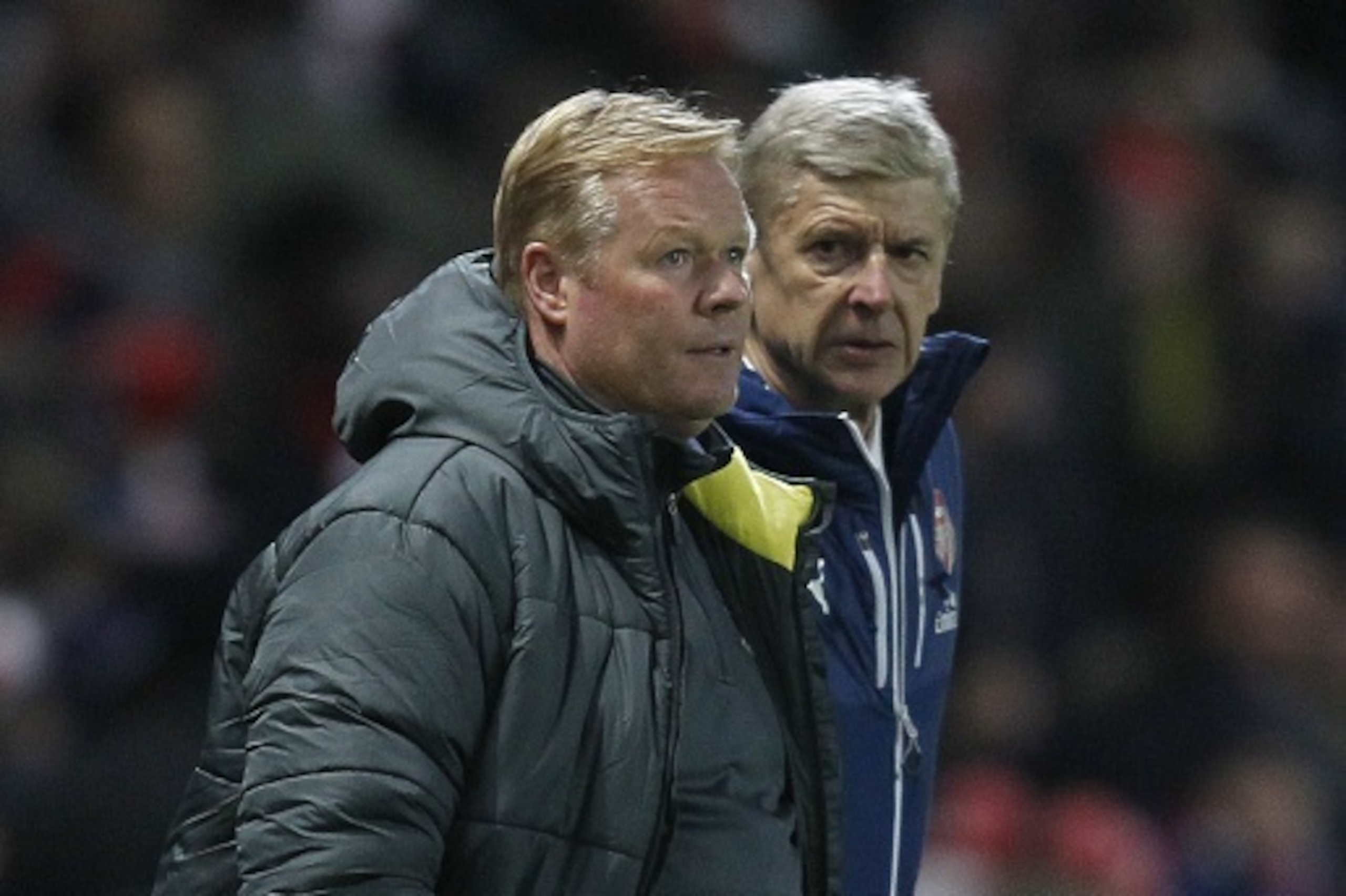 Southampton's Dutch manager Ronald Koeman (L) and Arsenal's French manager Arsene Wenger (R) watch the action during the English Premier League football match between Arsenal and Southampton at the Emirates Stadium in London on December 3, 2014. Arsenal w