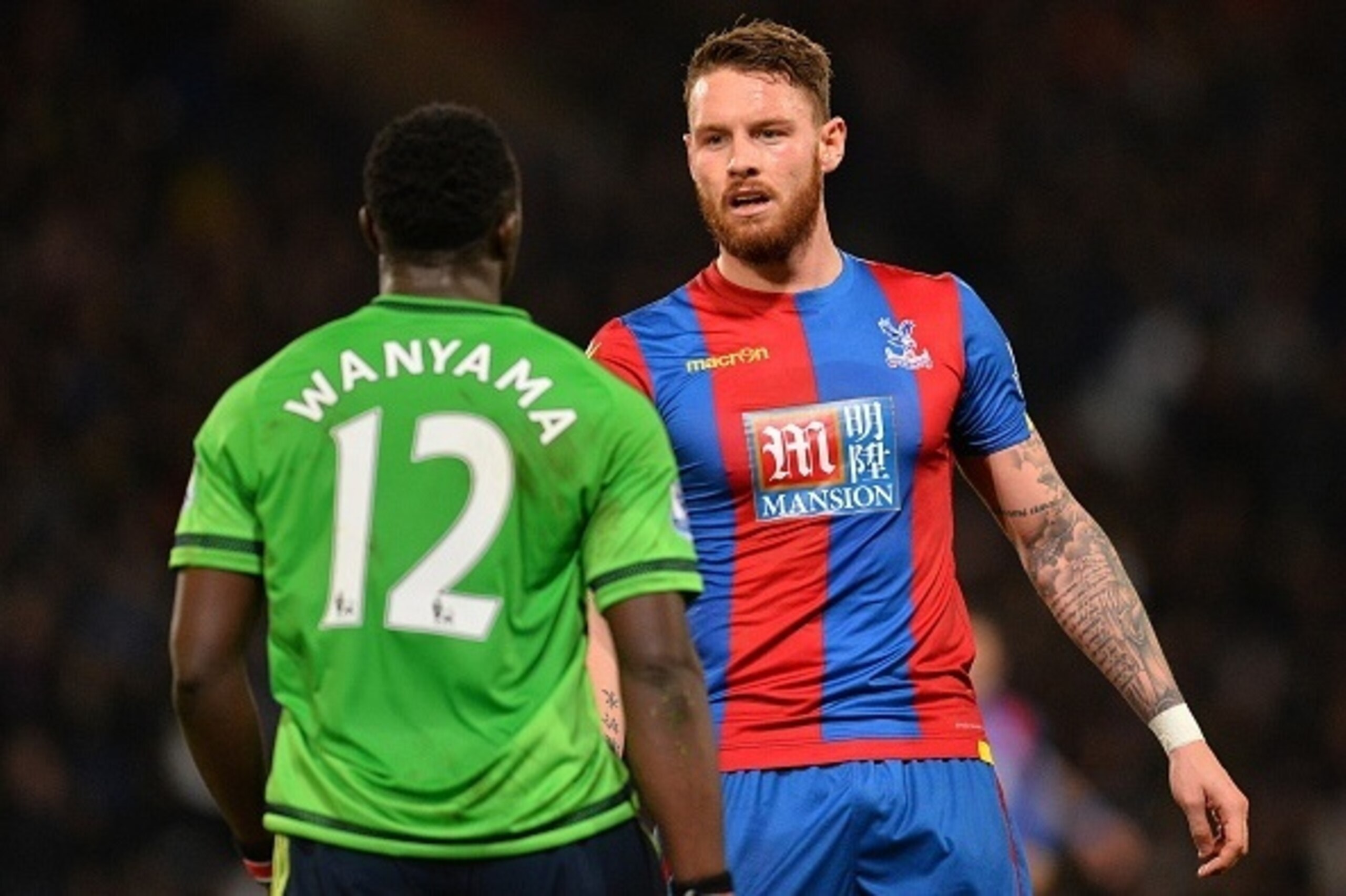 Southampton's Kenyan midfielder Victor Wanyama (L) exchanges words with Crystal Palace's English striker Connor Wickham during the English Premier League football match between Crystal Palace and Southampton at Selhurst Park in south London on December 12