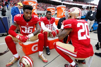SANTA CLARA, CA - DECEMBER 20: Dontae Johnson #36, Jimmie Ward #25 and Kenneth Acker #20 of the San Francisco 49ers relax on the sideline during the game against the Cincinnati Bengals at Levi Stadium on December 20, 2015 in Santa Clara, California. The B