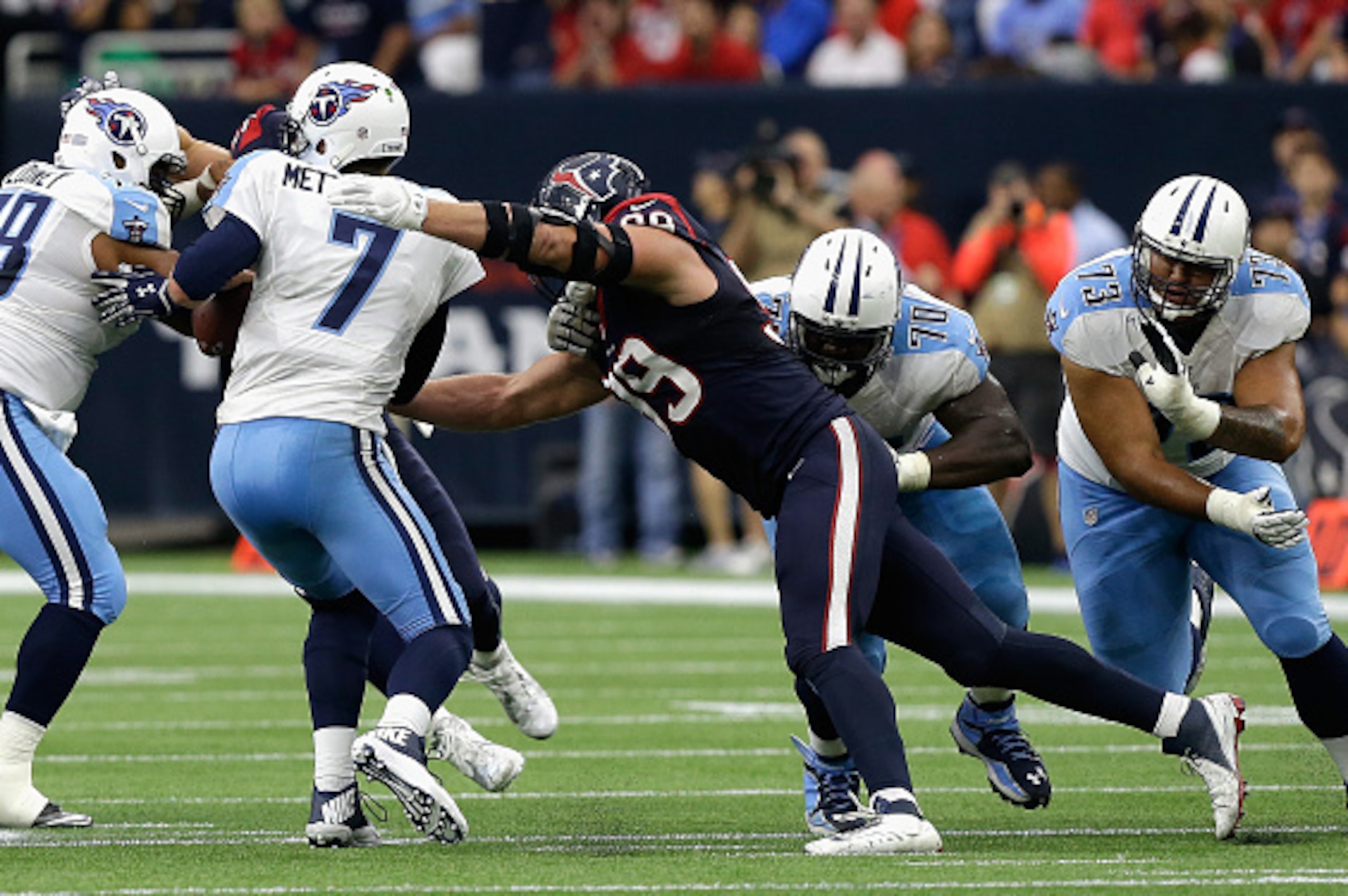 HOUSTON, TX - NOVEMBER 01:  Zach Mettenberger #7 of the Tennessee Titans is pressured by J.J. Watt #99 of the Houston Texans at NRG Stadium on November 1, 2015 in Houston, Texas.  (Photo by Bob Levey/Getty Images)