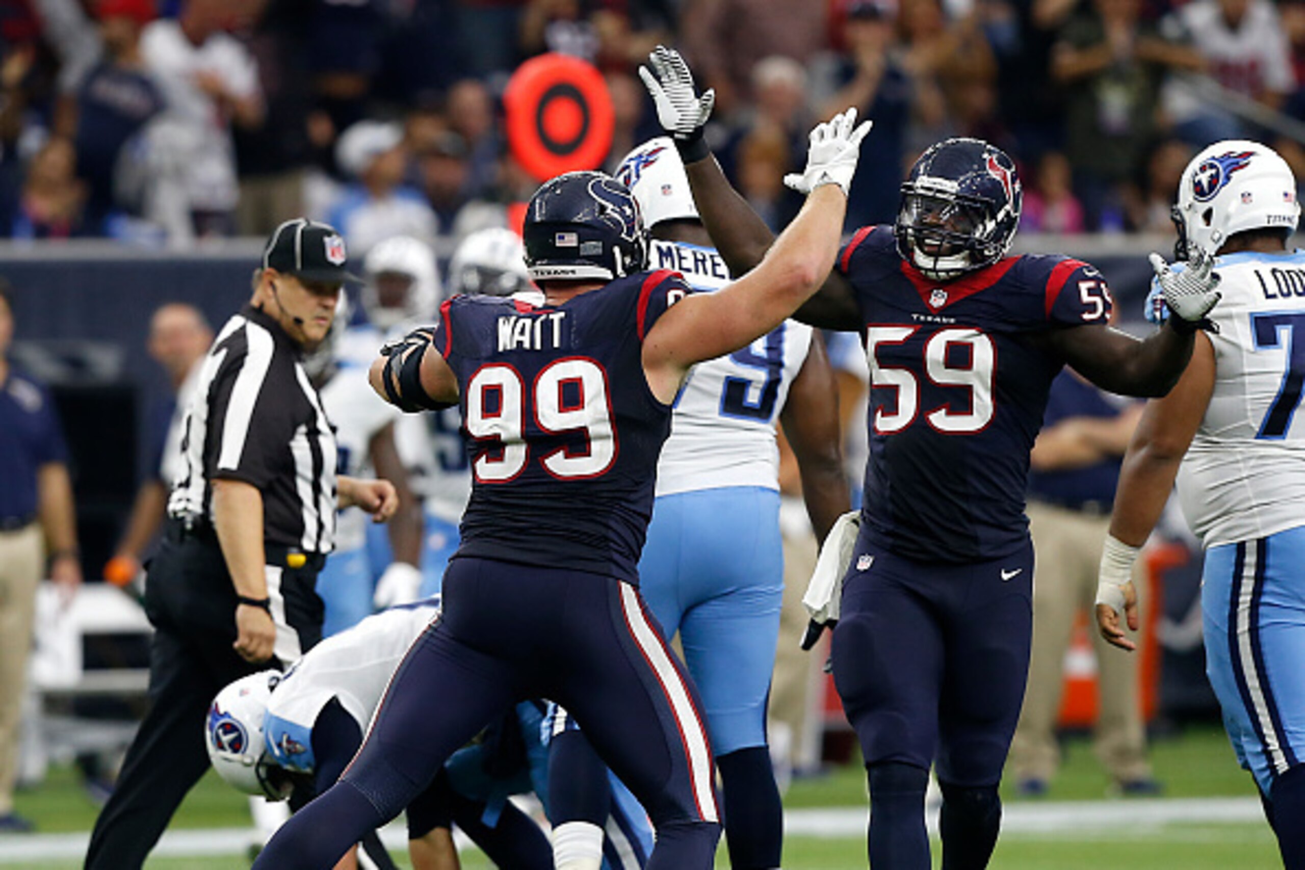 HOUSTON, TX - NOVEMBER 01:  J.J. Watt #99 of the Houston Texans and Whitney Mercilus #59 high five after a combined sack of Zach Mettenberger #7 of the Tennessee Titans at NRG Stadium on November 1, 2015 in Houston, Texas.  (Photo by Bob Levey/Getty Image