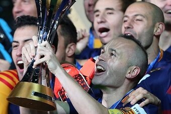 YOKOHAMA, JAPAN - DECEMBER 20: Andres Iniesta of Barcelona lifts the trophy following the FIFA Club World Cup Final match between River Plate and Barcelona at the International Stadium Yokohama on December 20, 2015 in Yokohama, Japan. (Photo by Chris Brun