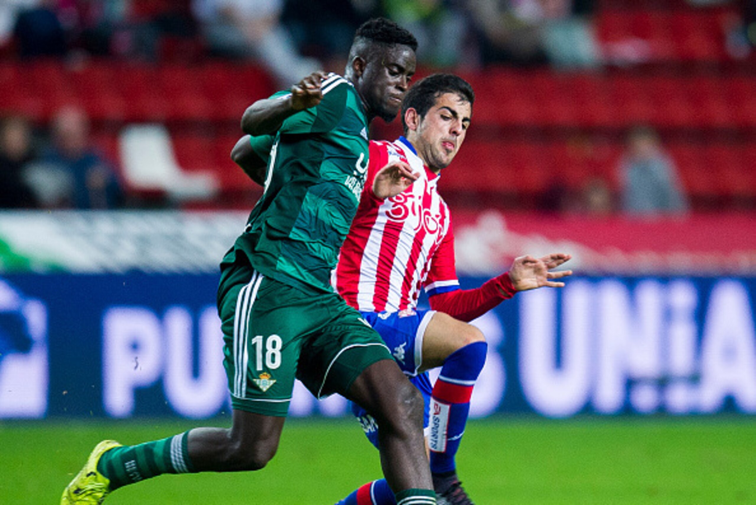 GIJON, SPAIN - DECEMBER 15: Alfred N'Diaye of Real Betis Balompie duels for the ball with Carlos Castro of Real Sporting de Gijon during the Copa del Rey Round of 32 match between Real Sporting de Gijon and Real Betis Balompie at Estadio El Molinon on De GIJON, SPAIN - DECEMBER 15: Alfred N'Diaye of Real Betis Balompie duels for the ball with Carlos Castro of Real Sporting de Gijon during the Copa del Rey Round of 32 match between Real Sporting de Gijon and Real Betis Balompie at Estadio El Molinon on De