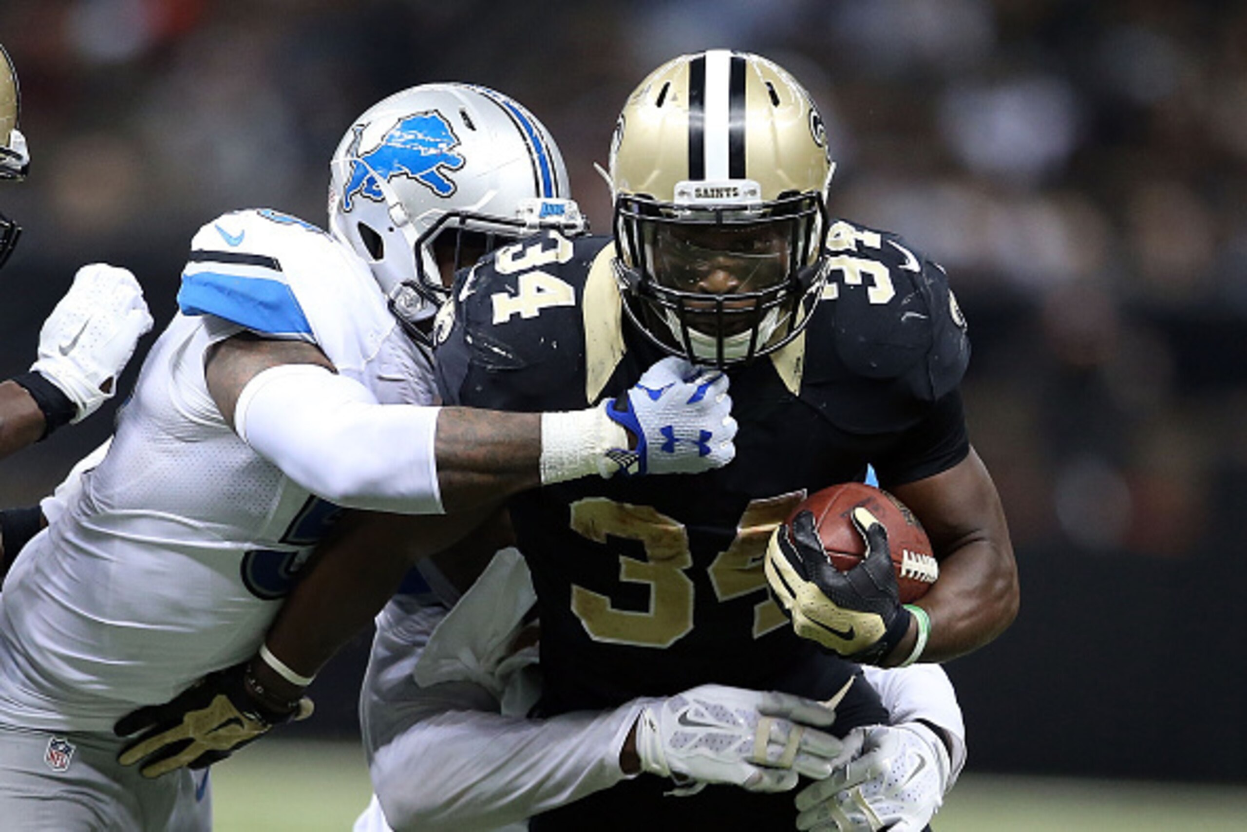 NEW ORLEANS, LA - DECEMBER 21:  Tim Hightower #34 of the New Orleans Saints is brought down by Tahir Whitehead #59 of the Detroit Lions during the fourth quarter of a game at the Mercedes-Benz Superdome on December 21, 2015 in New Orleans, Louisiana.  (Ph