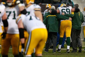 OAKLAND, CA - DECEMBER 20: Tackle David Bakhtiari #69 of the Green Bay Packers is assisted from the field in the fourth quarter against the Oakland Raiders at O.co Coliseum on December 20, 2015 in Oakland, California. (Photo by Lachlan Cunningham/Getty Im