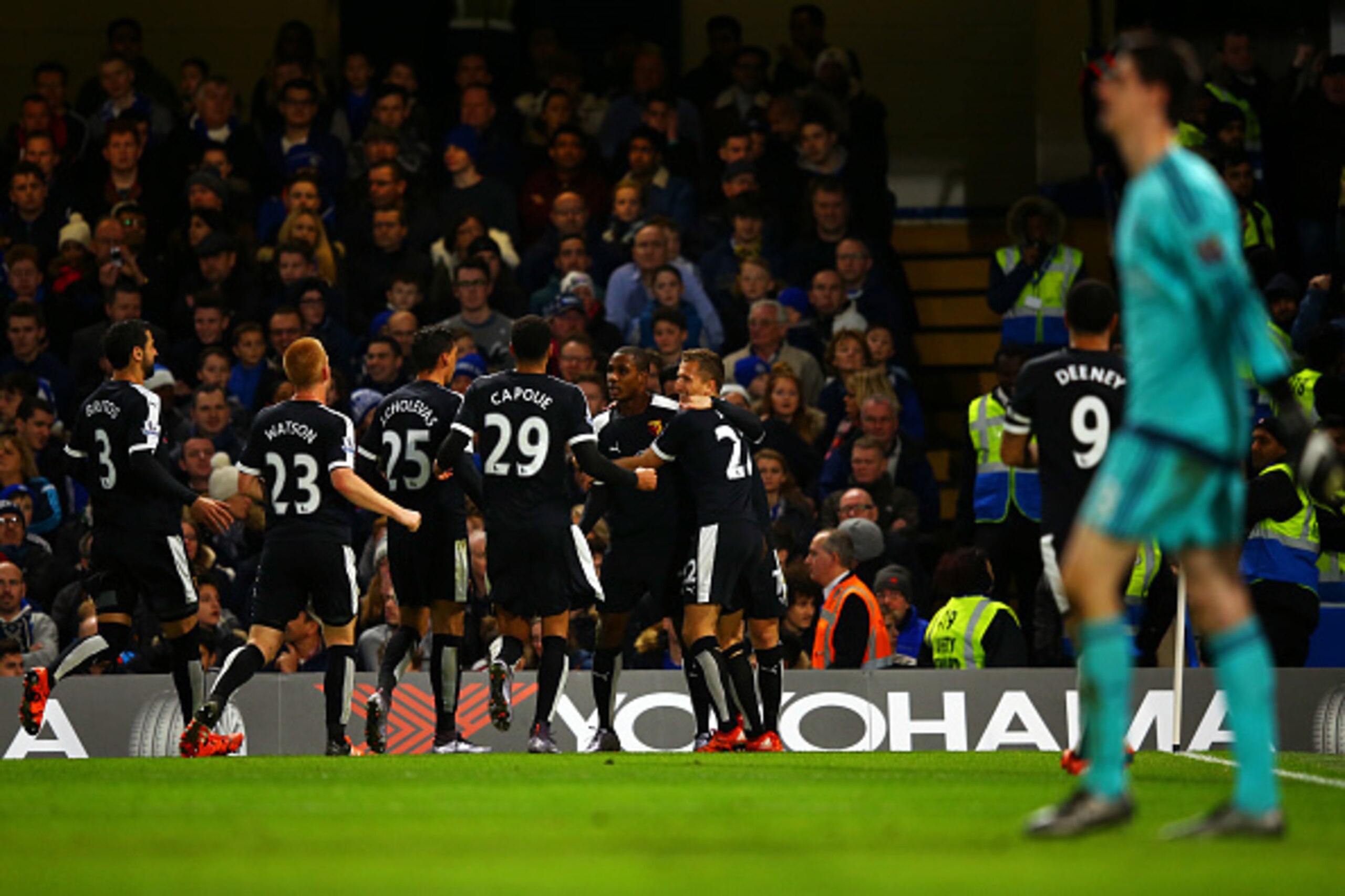LONDON, ENGLAND - DECEMBER 26:  Odion Ighalo of Watford celebrates with team-mates after scoring his team's second goal as Thibaut Courtois of Chelsea looks on during the Barclays Premier League match between Chelsea and Watford at Stamford Bridge on Dece