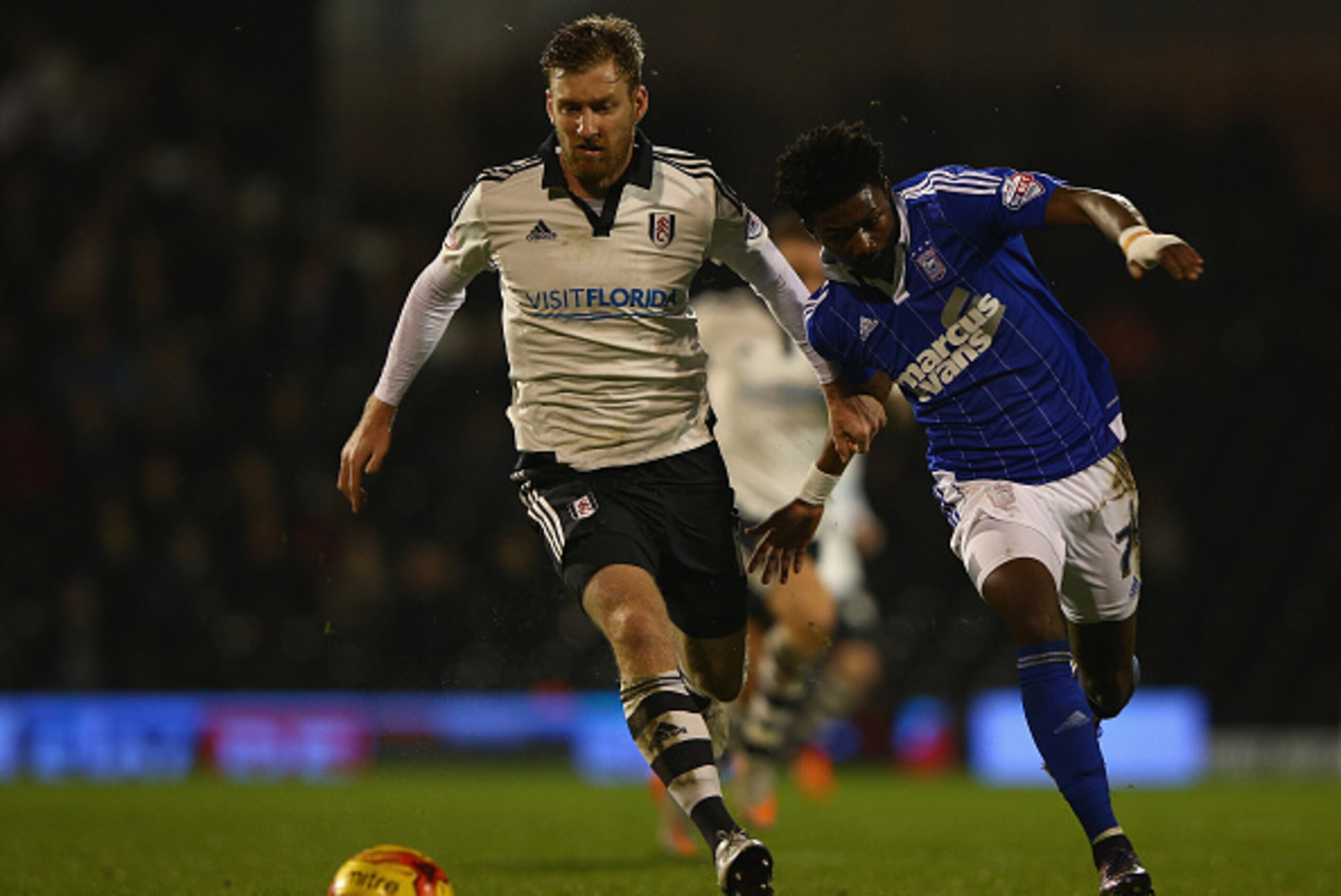 LONDON, ENGLAND - DECEMBER 15:  Tim Ream of Fulham tries to tackle Ainsley Maitland-Miles of Ipswich during the Sky Bet Football League Championship match between Fulham and Ipswich Town at Craven Cottage  on December 15, 2015 in London, United Kingdom.  