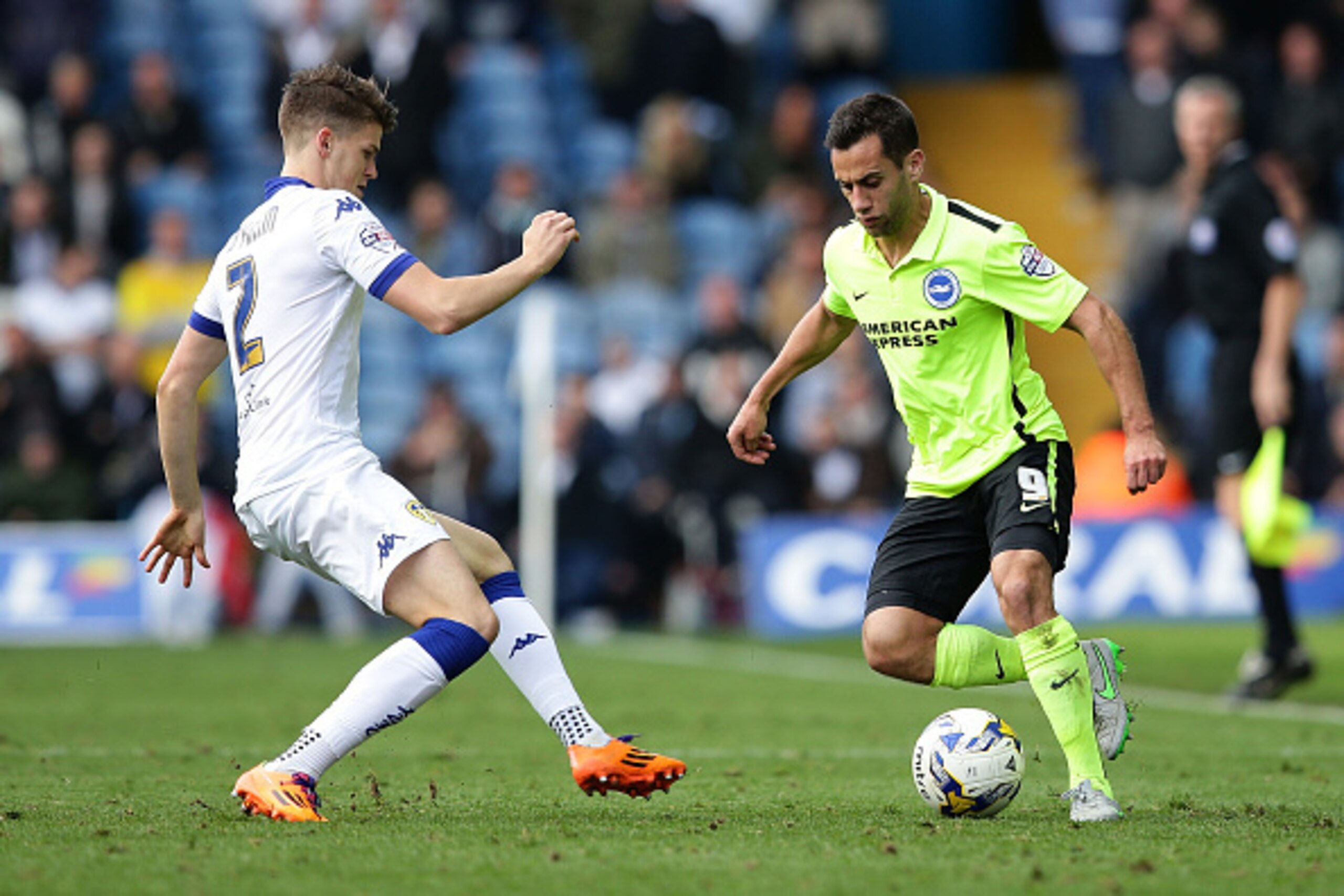 LEEDS, ENGLAND - OCTOBER 17: Sam Baldock of Brighton & Hove Albion FC maintains control of the ball over Sam Byram of Leeds United FC during the Sky Bet Championship match between Leeds United and Brighton & Hove Albion at Elland Road on October 17, 2015 