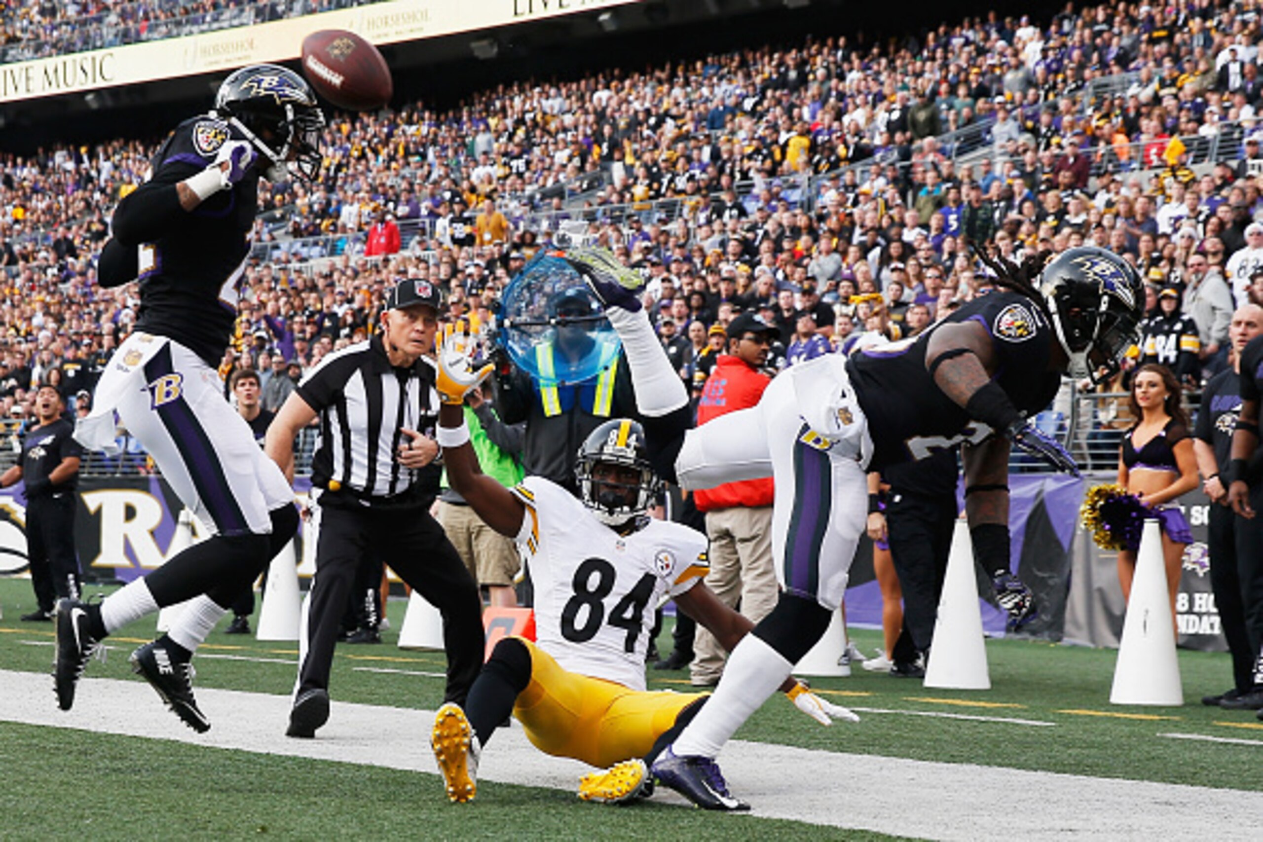BALTIMORE, MD - DECEMBER 27:  Kendrick Lewis #23 of the Baltimore Ravens is called for pass interference after running into Jimmy Smith #22 of the Baltimore Ravens and  Antonio Brown #84 of the Pittsburgh Steelers at M&T Bank Stadium on December 27, 2015 