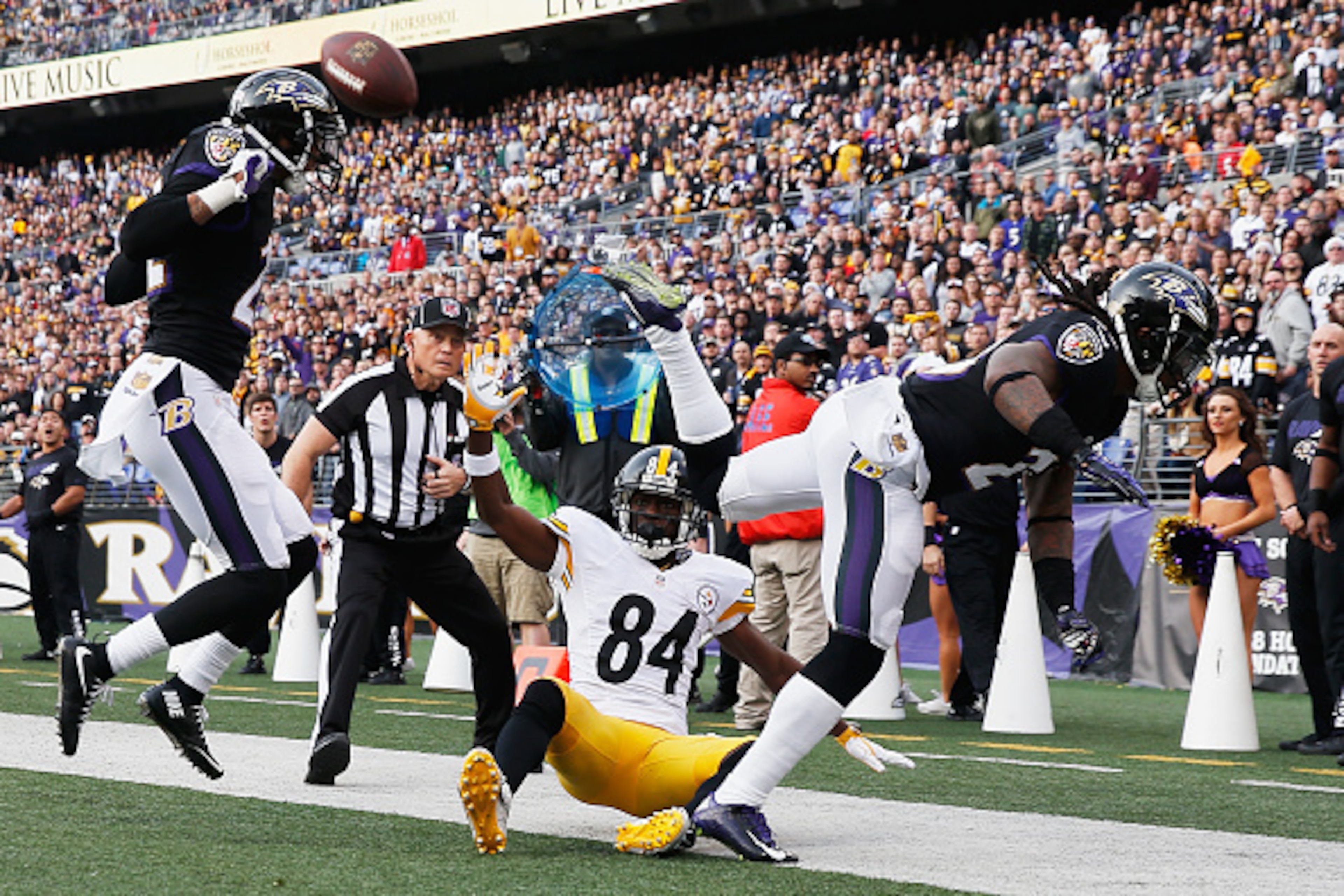 BALTIMORE, MD - DECEMBER 27:  Kendrick Lewis #23 of the Baltimore Ravens is called for pass interference after running into Jimmy Smith #22 of the Baltimore Ravens and  Antonio Brown #84 of the Pittsburgh Steelers at M&T Bank Stadium on December 27, 2015 