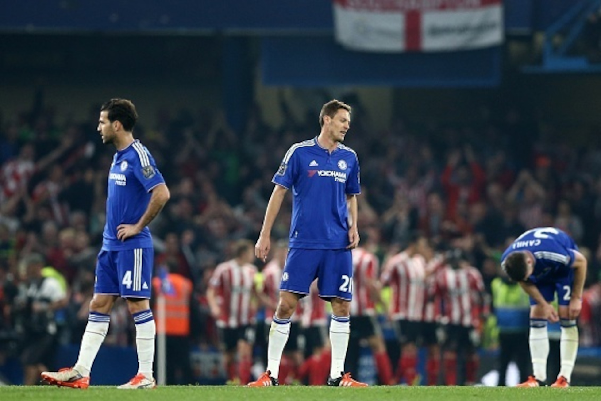 Chelsea's Spanish midfielder Cesc Fabregas (L), Chelsea's Serbian midfielder Nemanja Matic and Chelsea's English defender Gary Cahill (R) reacts after conceding their second goal during the English Premier League football match between Chelsea and Southam