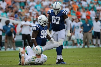 MIAMI GARDENS, FL - DECEMBER 27:  Ryan Tannehill #17 of the Miami Dolphins is sacked by Kendall Langford #90 of the Indianapolis Colts during a game  at Sun Life Stadium on December 27, 2015 in Miami Gardens, Florida.  (Photo by Mike Ehrmann/Getty Images)
