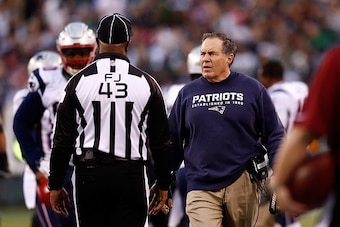 EAST RUTHERFORD, NJ - DECEMBER 27: Head coach Bill Belichick of the New England Patriots talks with a referee during their game against the New York Jets at MetLife Stadium on December 27, 2015 in East Rutherford, New Jersey.  (Photo by Jeff Zelevansky/Ge