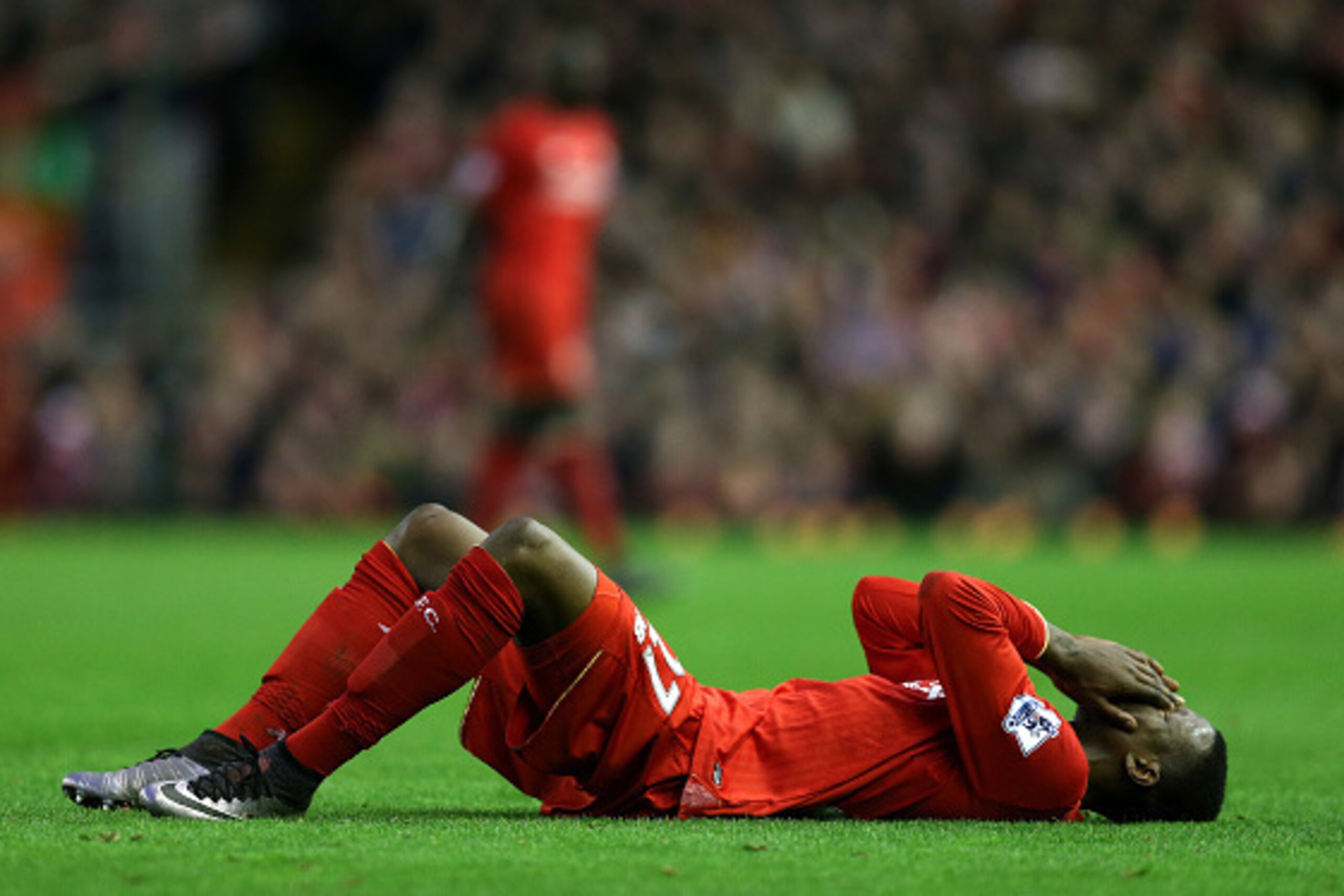 LIVERPOOL, ENGLAND - DECEMBER 26:  Divock Origi of Liverpool lies injured during the Barclays Premier League match between Liverpool and Leicester City at Anfield on December 26, 2015 in Liverpool, England.  (Photo by Chris Brunskill/Getty Images)