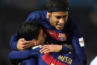 Barcelona forward Luis Suarez (L) celebrates his goal with Barcelona forward Lionel Messi and Barcelona forward Neymar (top) during the Club World Cup football final against River Plate in Yokohama on December 20, 2015.  AFP PHOTO / TOSHIFUMI KITAMURA / A