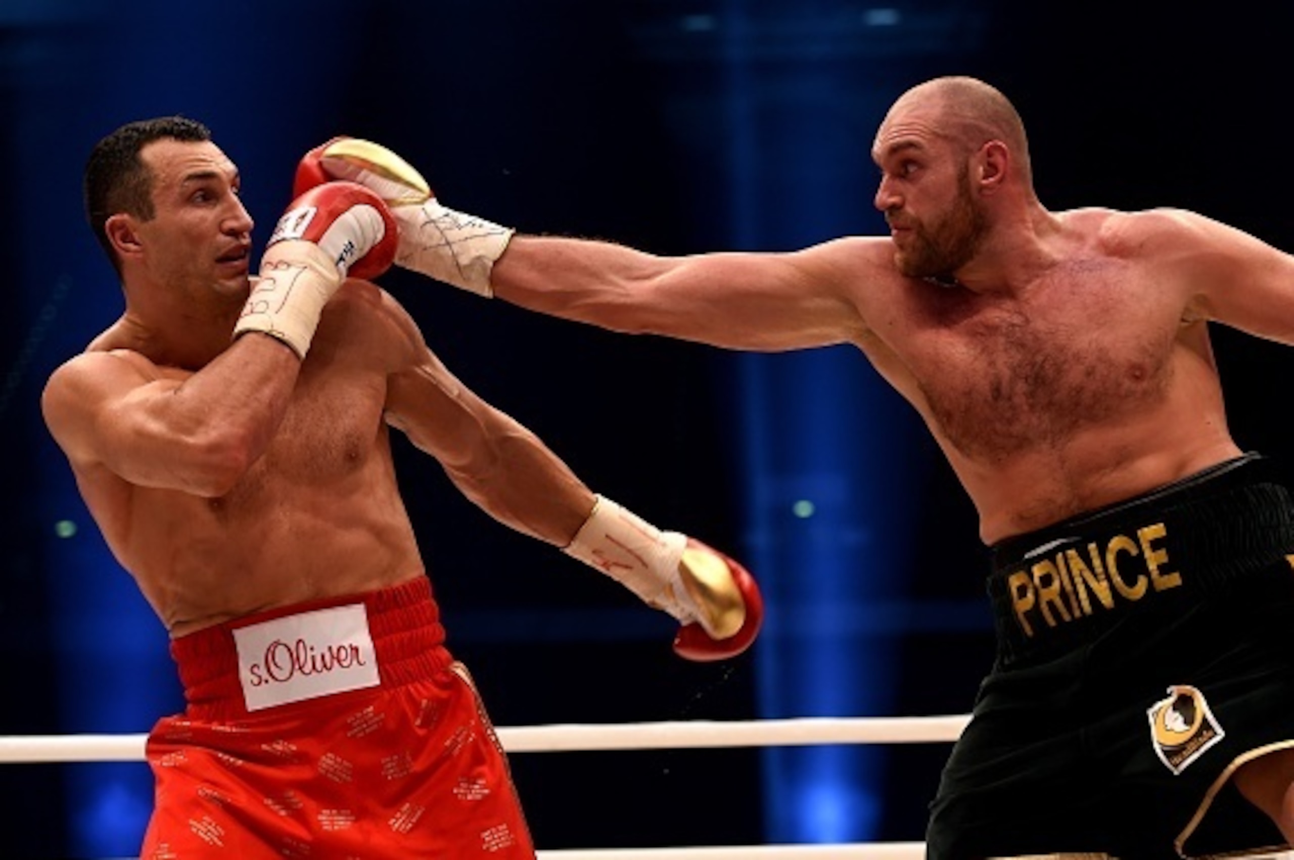 World heavyweight boxing champion Wladimir Klitschko (L) of Ukraine defends against Britain's Tyson Fury during their  WBA, IBF, WBO and IBO title bout in Duesseldorf, western Germany, on November 28, 2015.   Fury dethroned  Klitschko in a 12round decisio