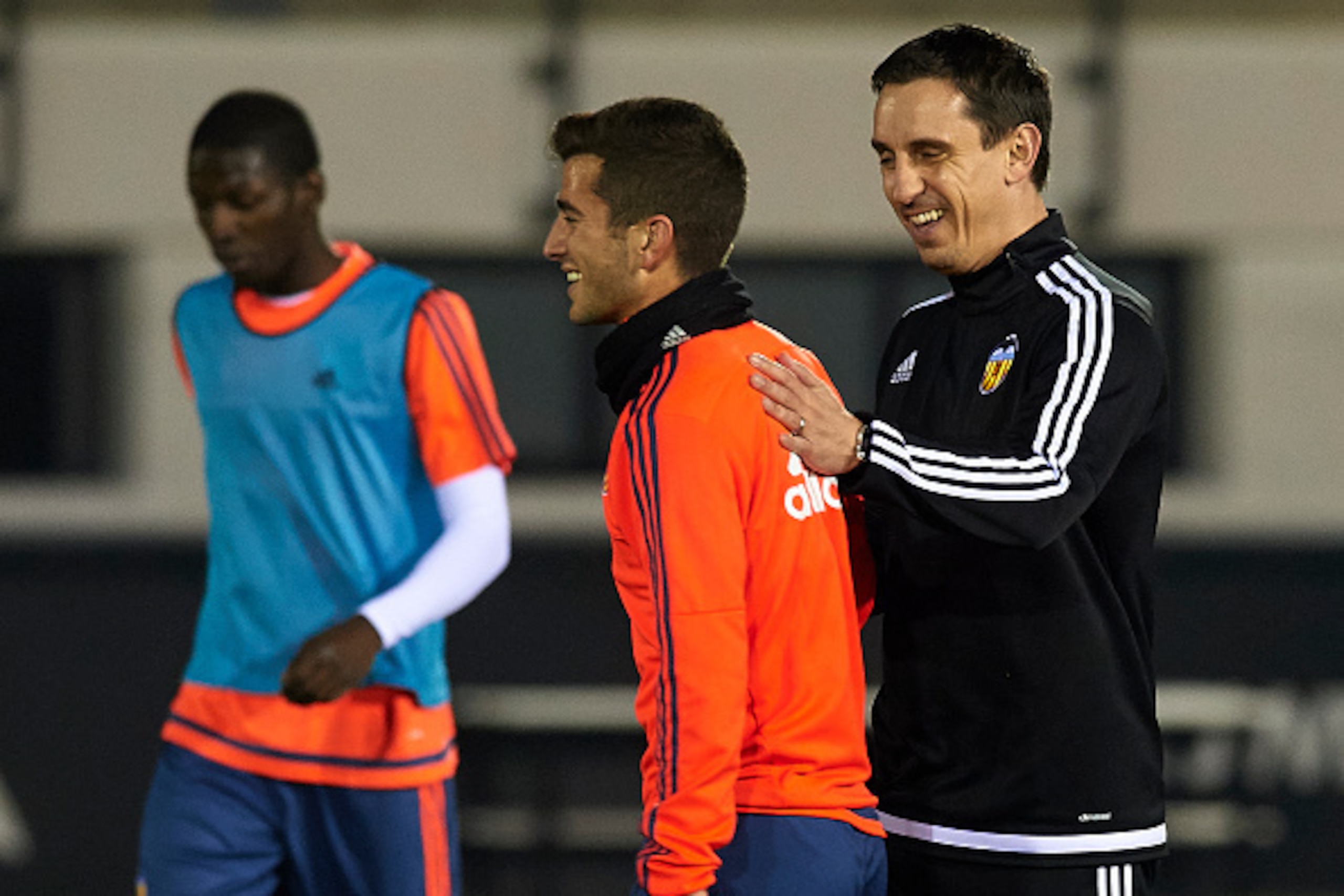 VALENCIA, SPAIN - DECEMBER 07:  Gary Neville (R) the new manager of Valencia CF reacts to his player Jose Gaya during a training session ahead of Wednesday's UEFA Champions League Group H match against Olympique Lyonnais at Paterna Training Centre on Dece